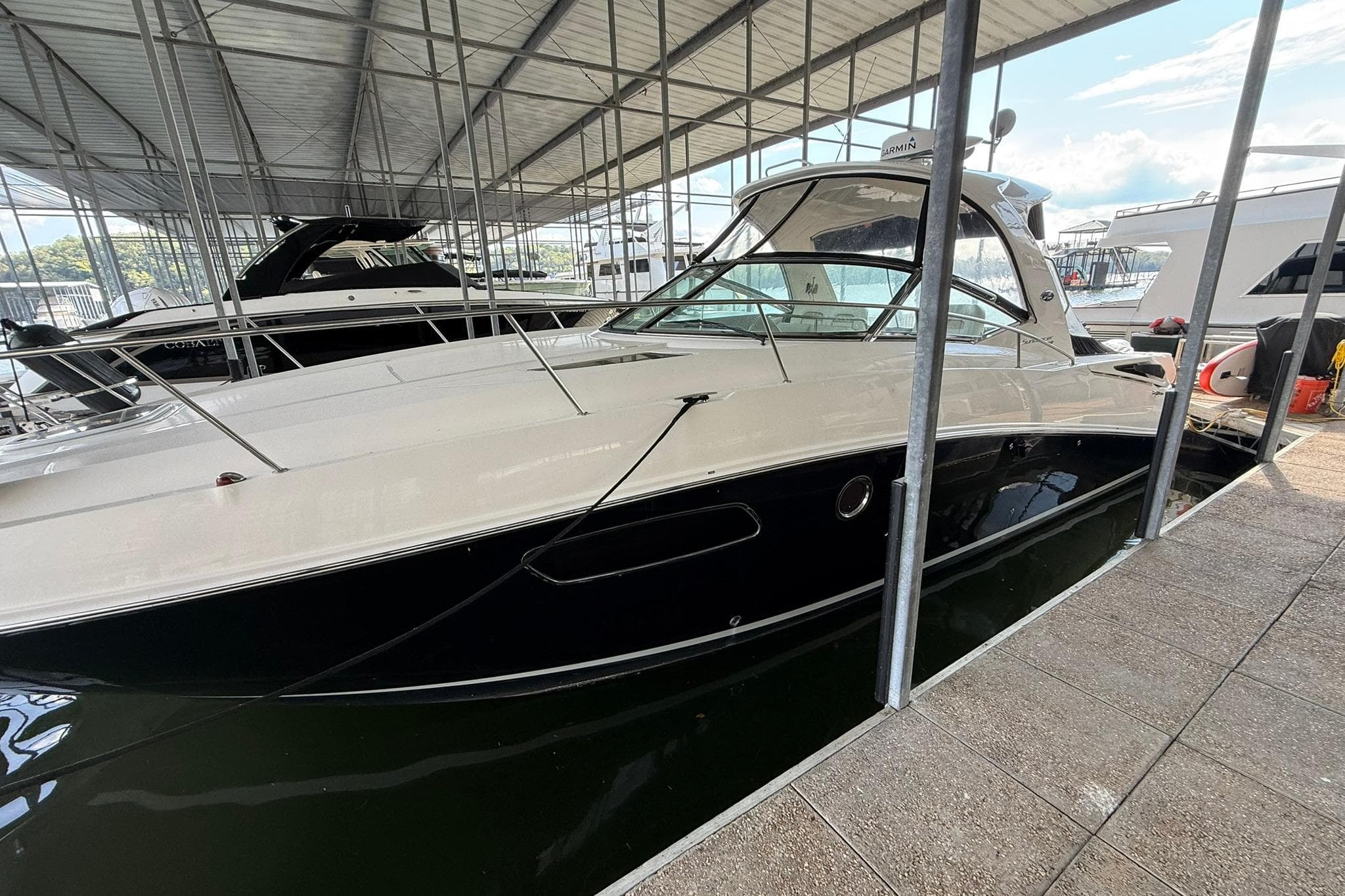 2009 Sea Ray 350 Sundancer docked in a covered marina.