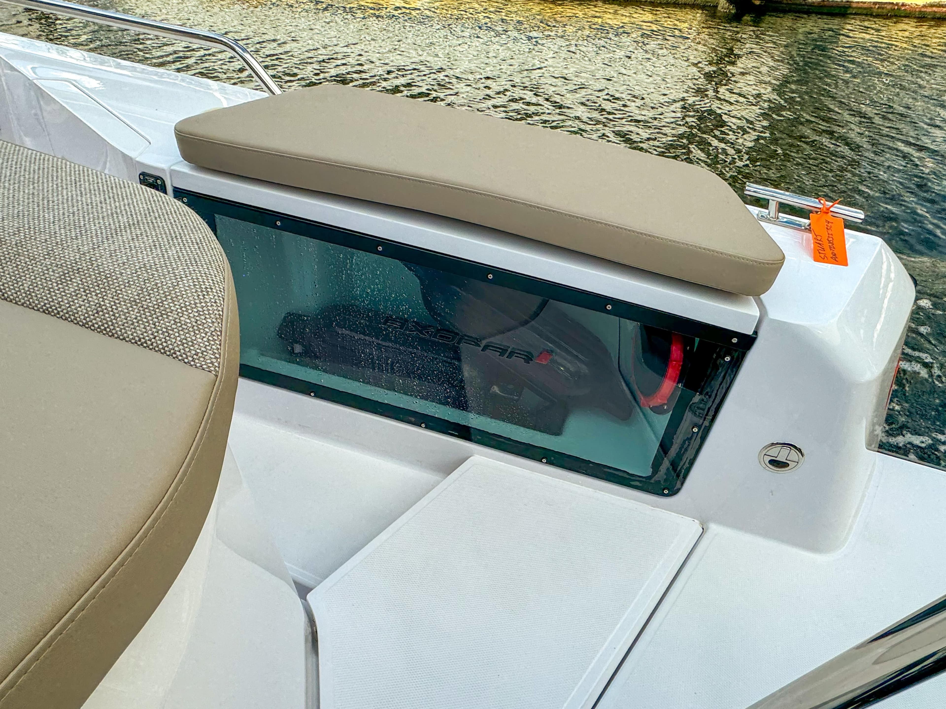 2024 Axopar 37XC CROSS CABIN boat interior with cushioned seating and water view.