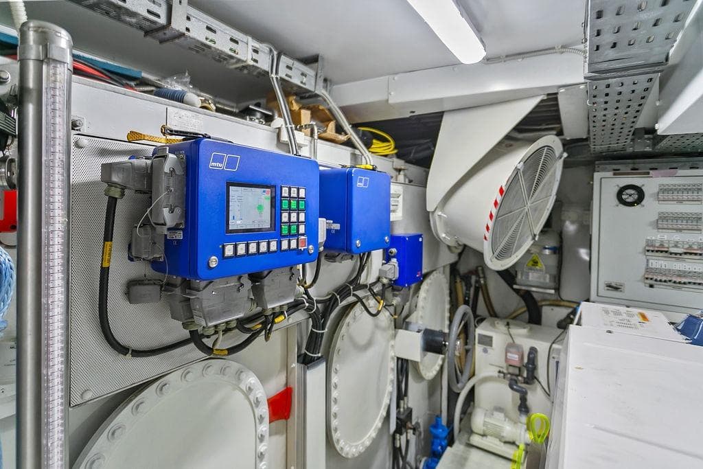 Engine room of 2011 Baia model xxx yacht with control panels and machinery.