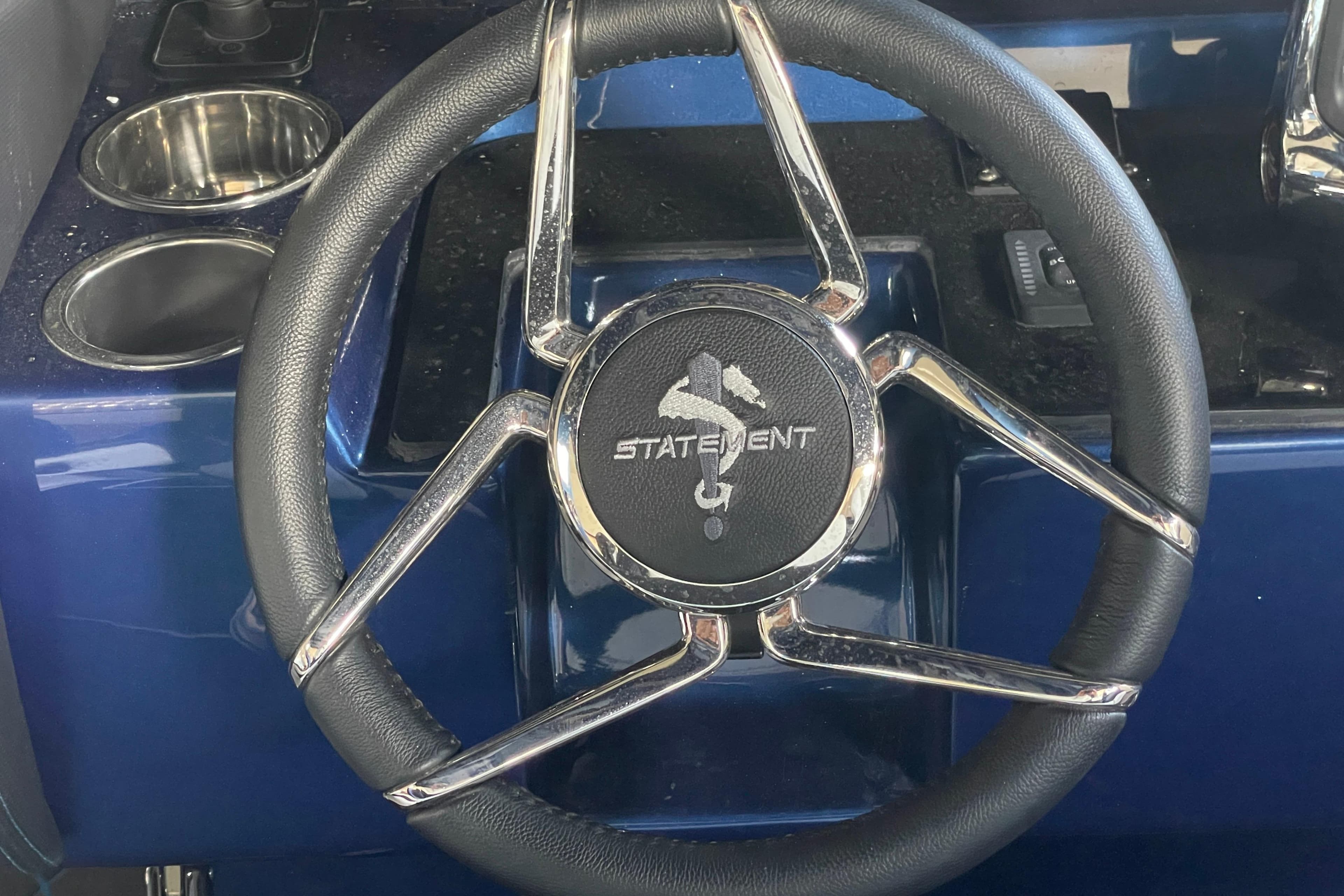 Steering wheel of 2027 Statement 350 Open boat with chrome accents.