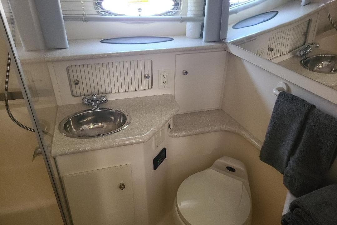 Bathroom interior of 2003 Carver 356 Aft Cabin Motor Yacht with sink and toilet.