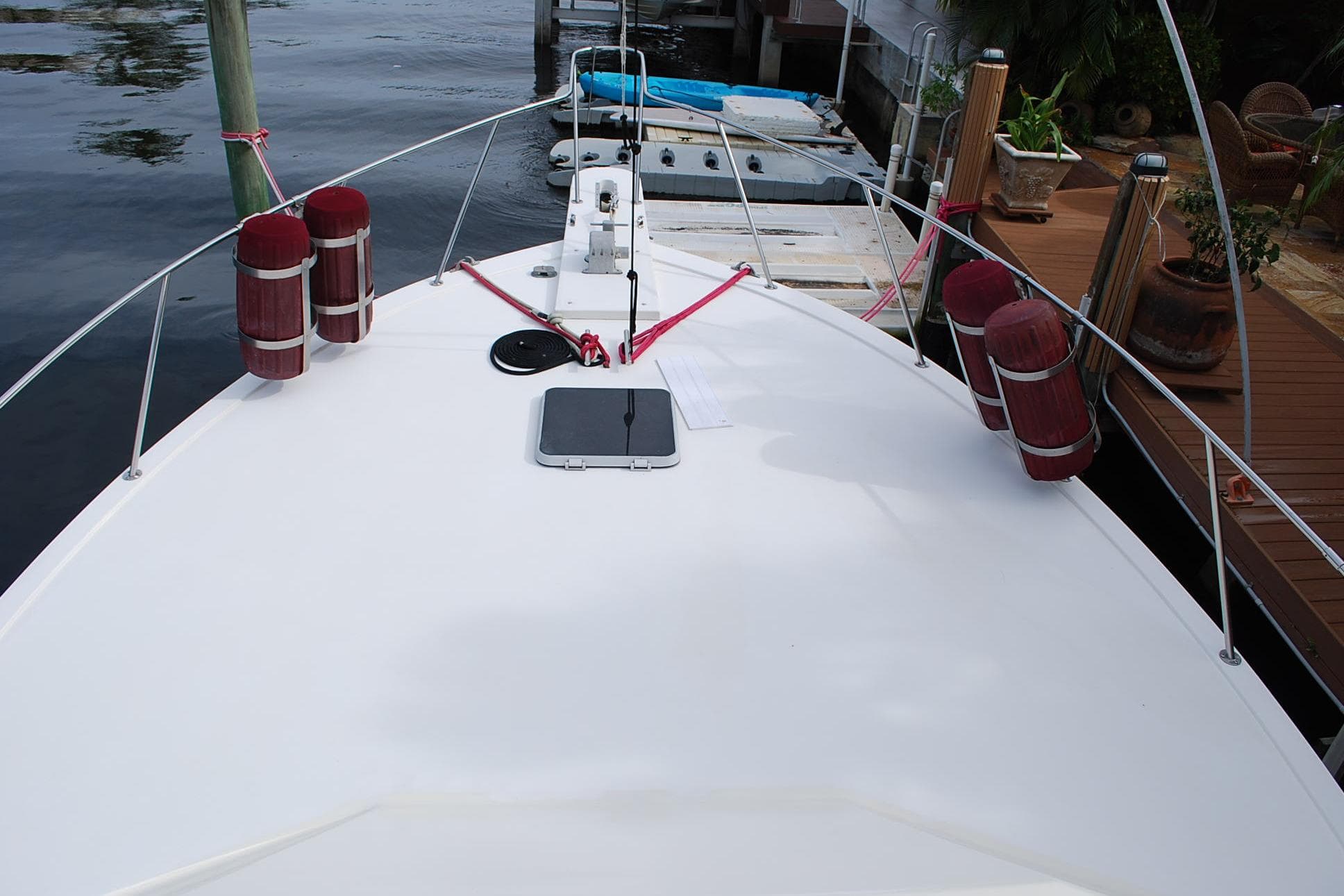 1987 Jersey Dawn boat docked, featuring a clean white deck and red fenders.