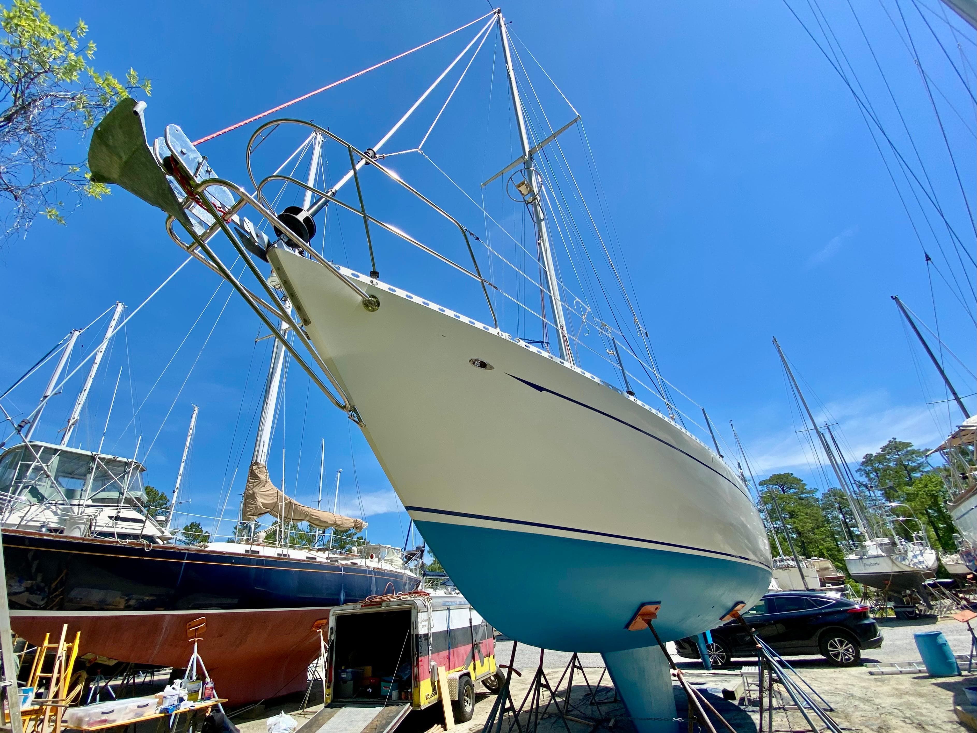 1979 Valiant 37 sailboat on dry dock under clear blue sky.