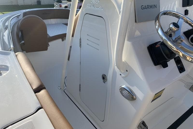 2026 Pioneer ISLANDER 202 boat interior with Garmin navigation and seating area.