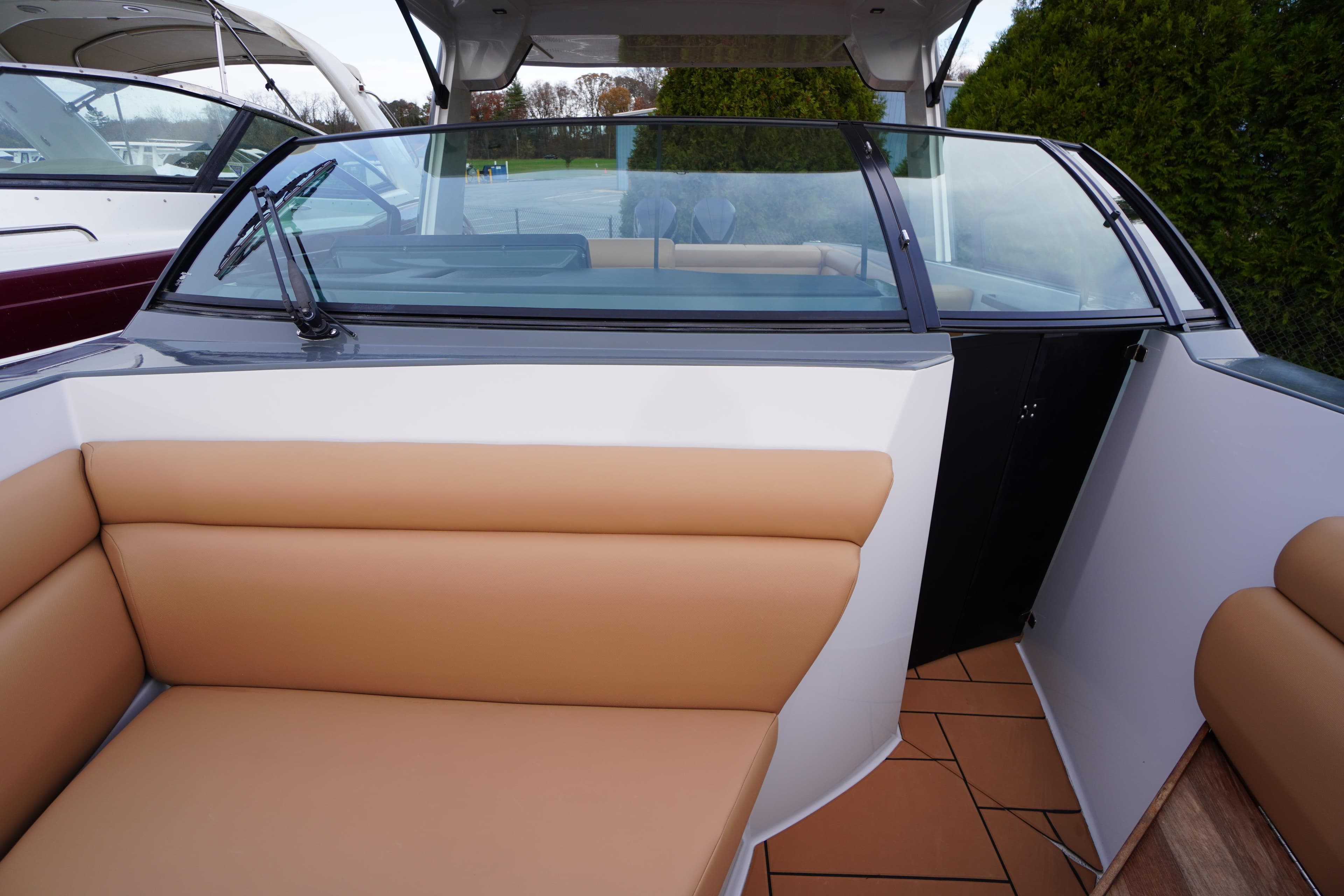 2020 Aviara AV32 OB boat interior with tan seating and glass windshield.