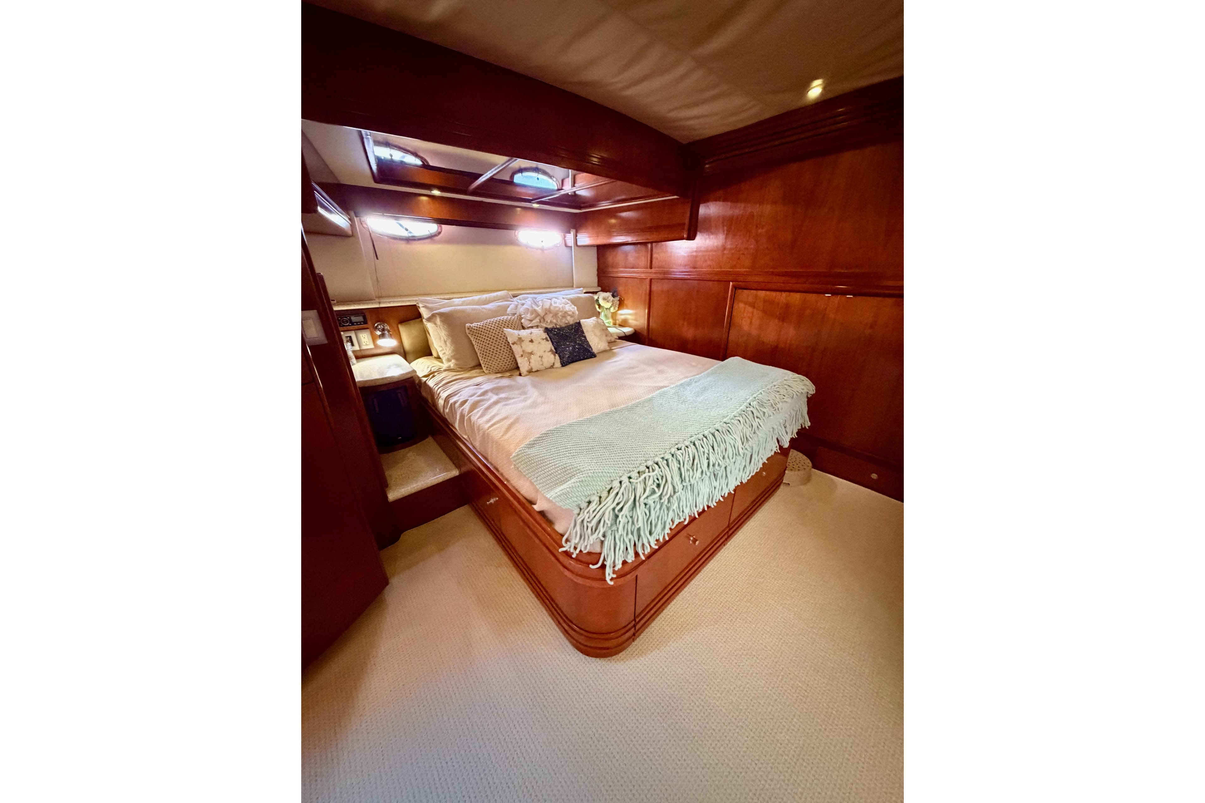Luxurious bedroom interior of 1999 Carver 530 Voyager Pilothouse yacht with elegant wood finish.
