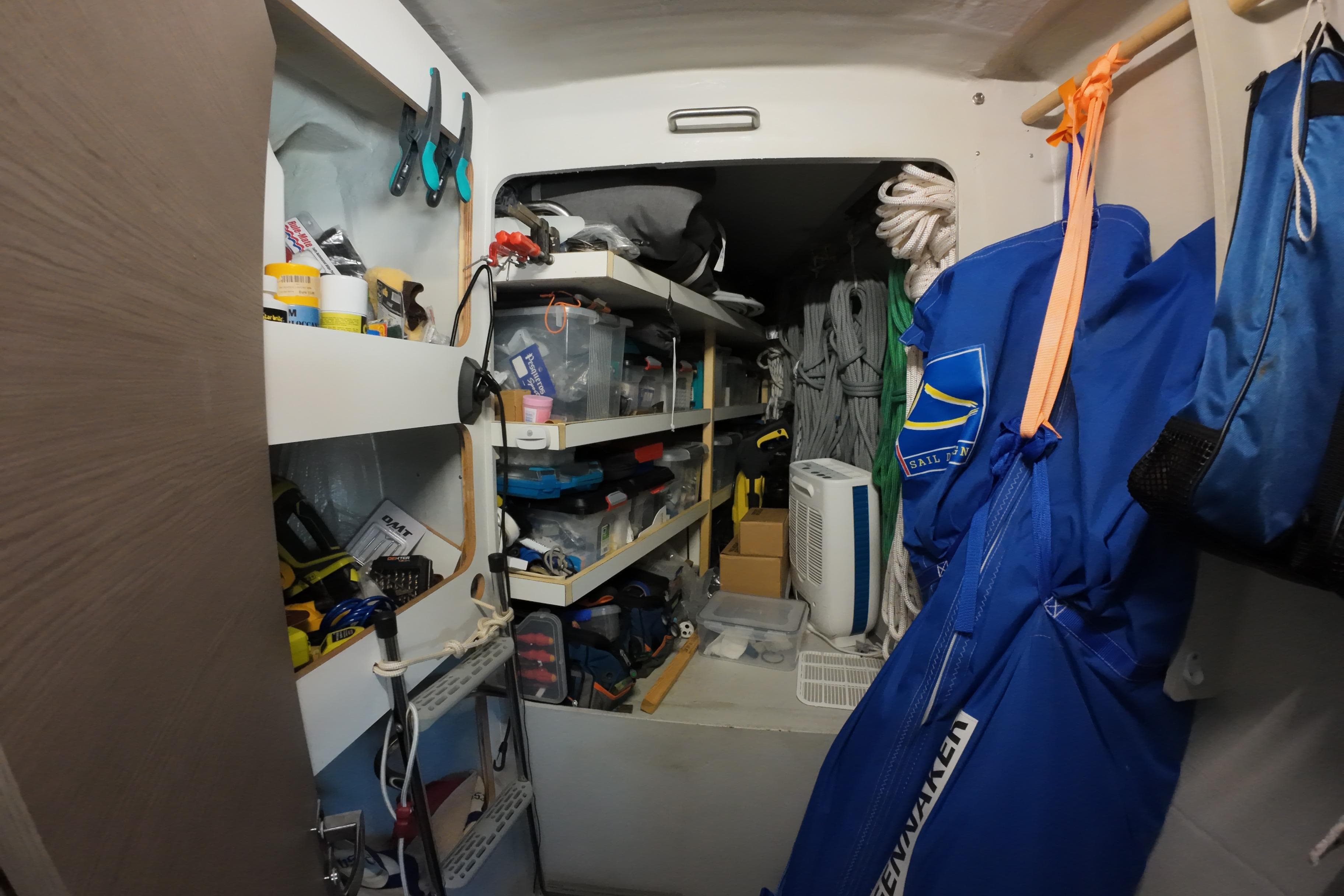 Storage area inside 2022 Fountaine Pajot Tanna 47 yacht, featuring shelves and sailing gear.