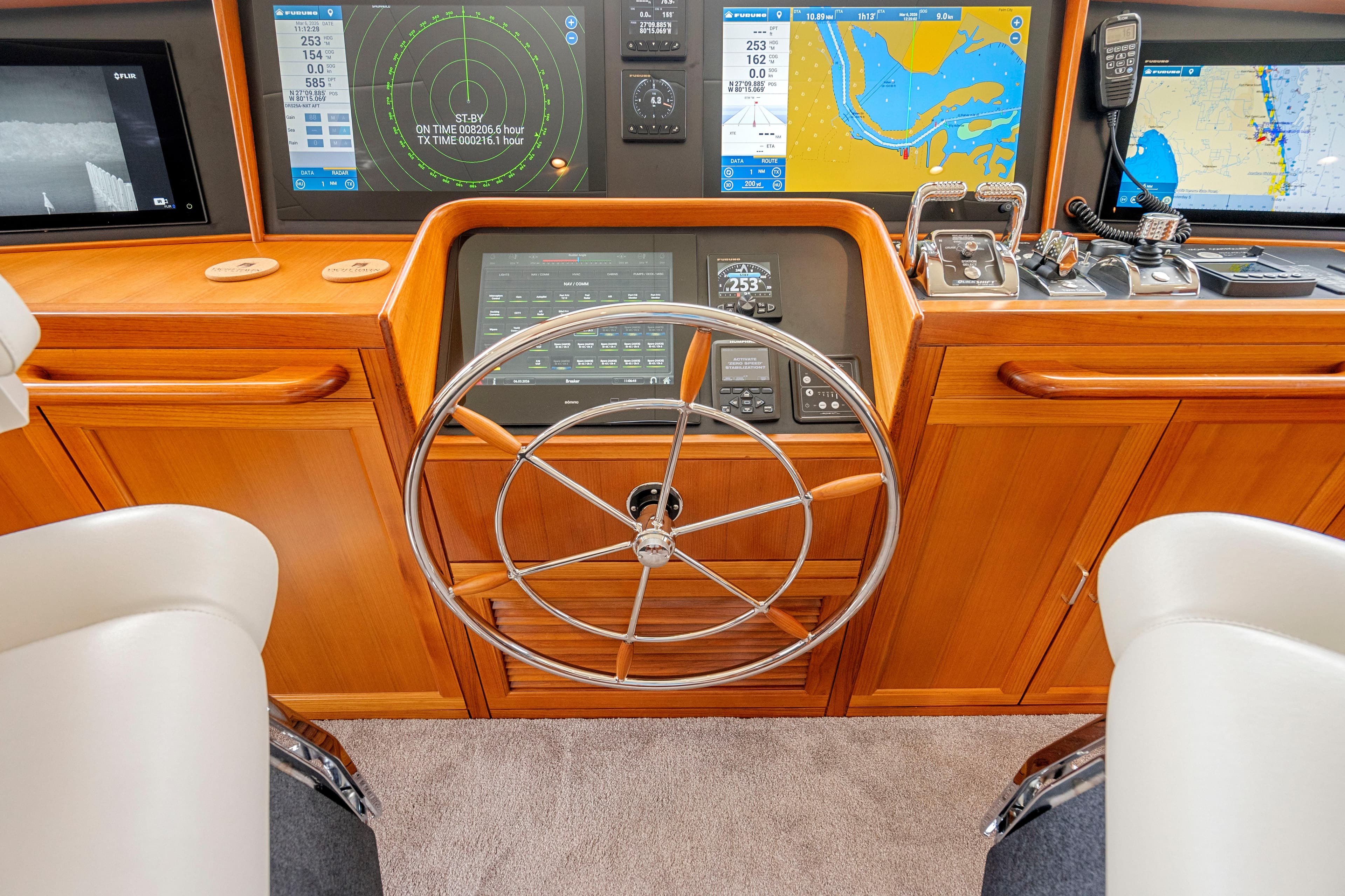 Helm of 2023 Fleming 85 yacht with advanced navigation displays and controls.