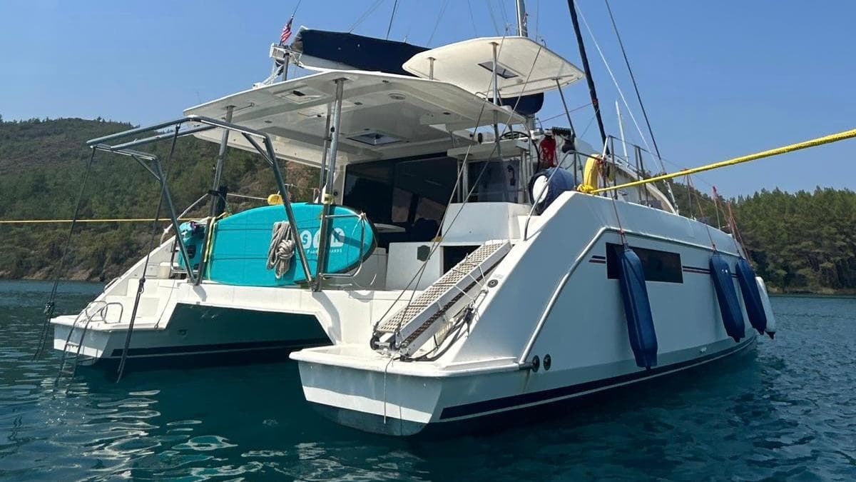 2018 Leopard 40 catamaran anchored in serene waters with lush green hills in the background.