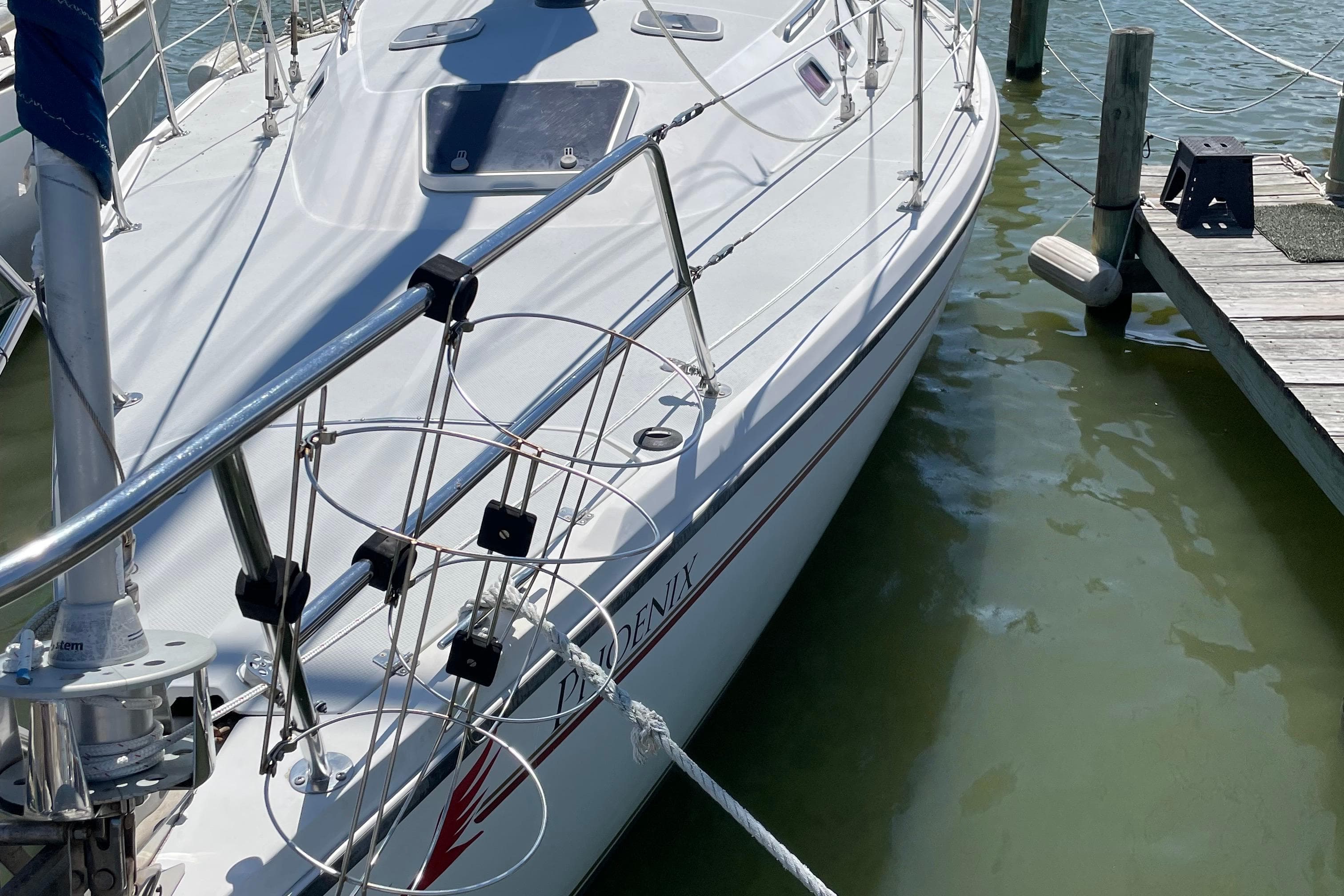1995 Catalina 36 MkII sailboat docked at marina, side view.