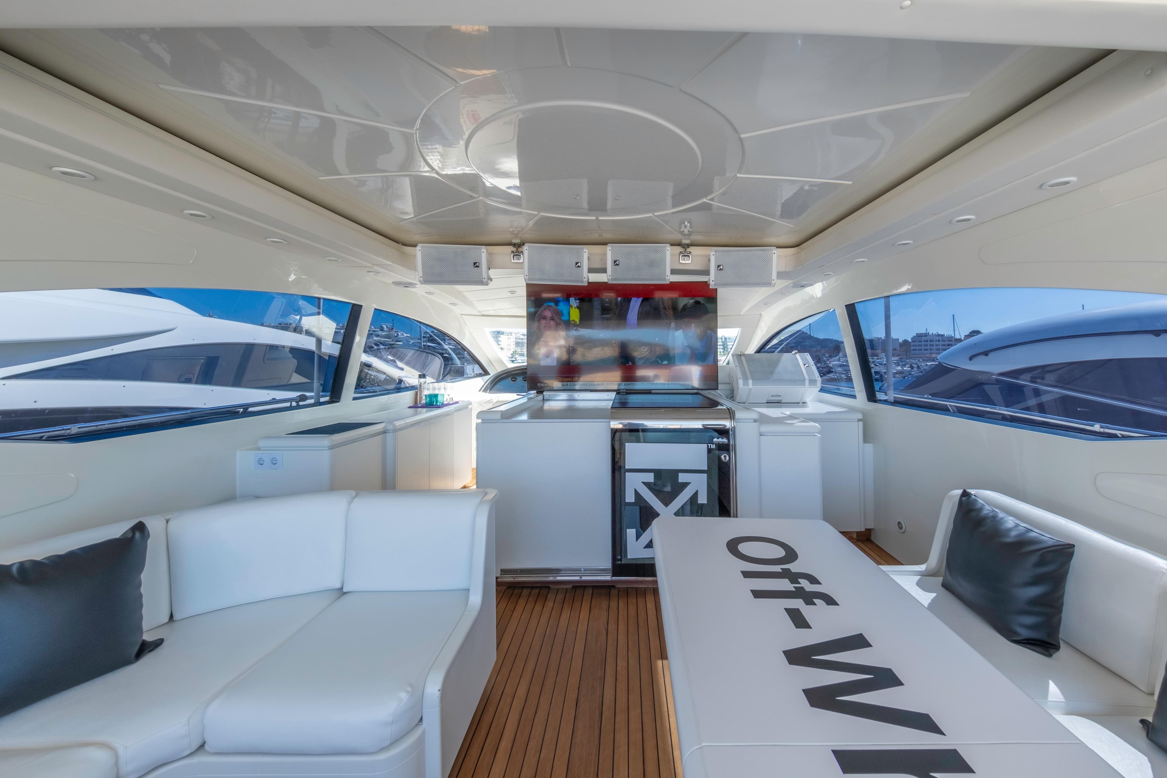 Luxurious interior of a 2002 Mangusta 72 yacht with modern seating and sleek design.