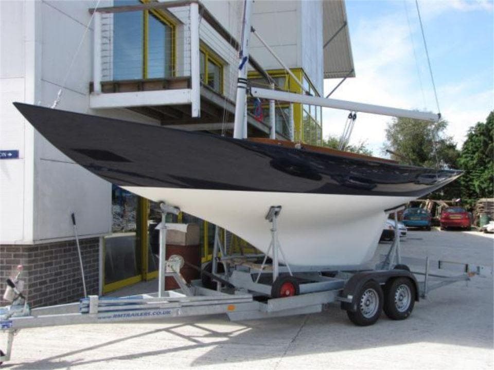 2025 Rustler 24 sailboat on trailer outside building.