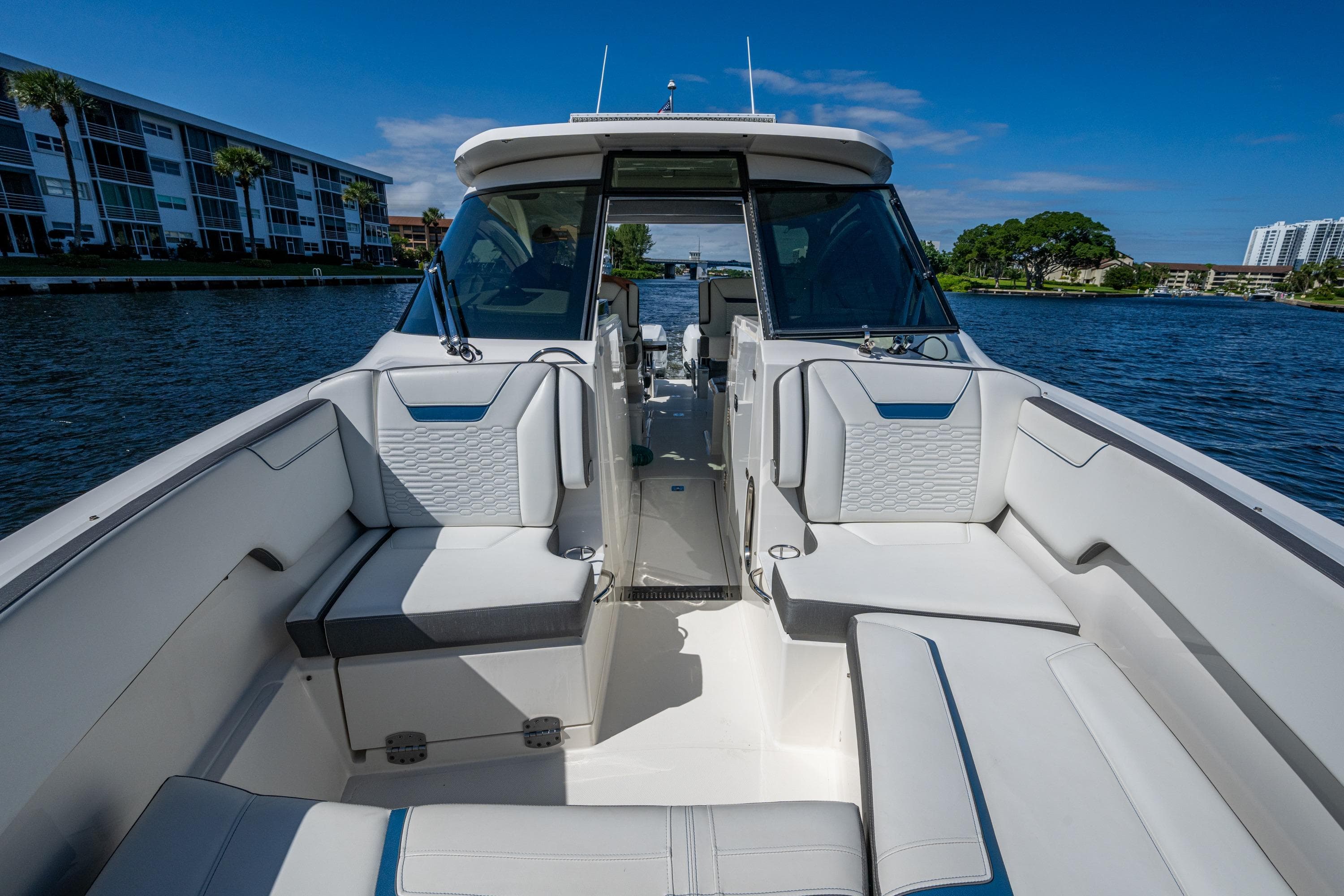 2021 Tiara Yachts 34 LX boat interior with luxurious seating on a sunny day.