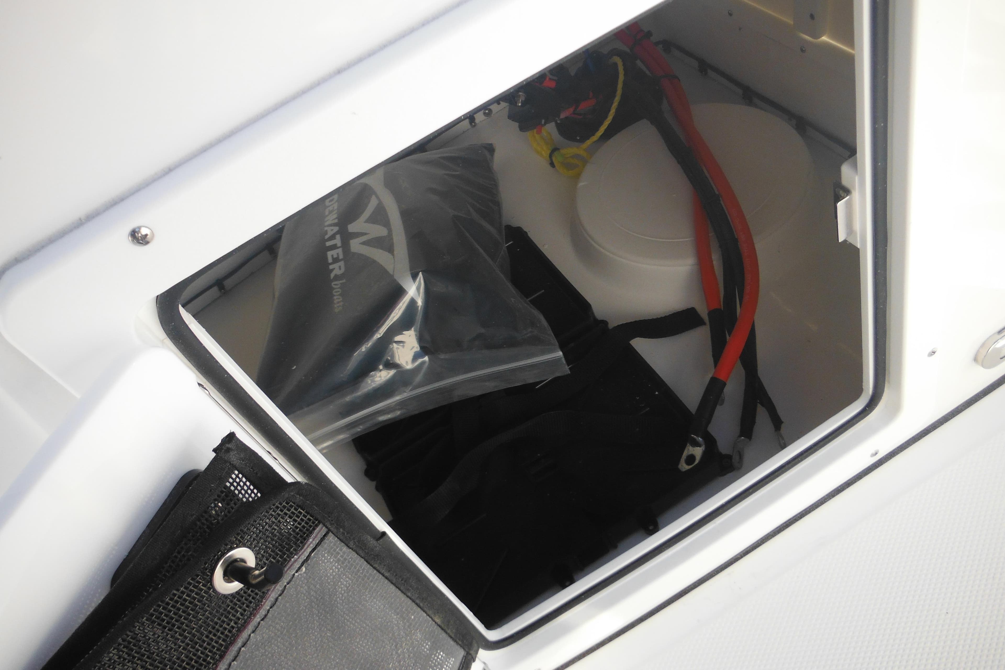 Storage compartment of 2026 Tidewater 180 CC Adventure boat with cables and equipment.