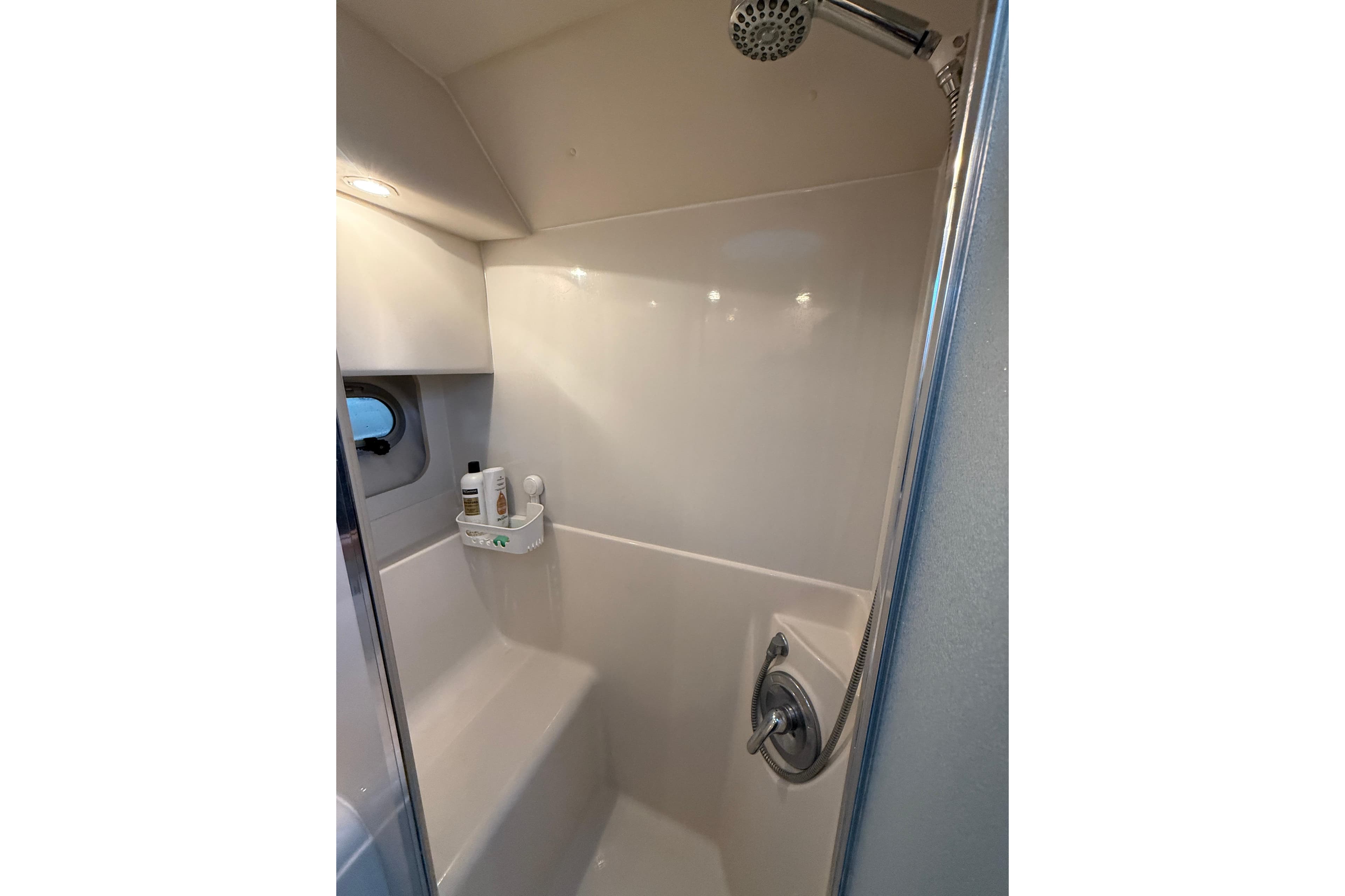 Shower area in 2001 Bayliner 3388 Command Bridge Motoryacht, featuring modern fixtures and storage.