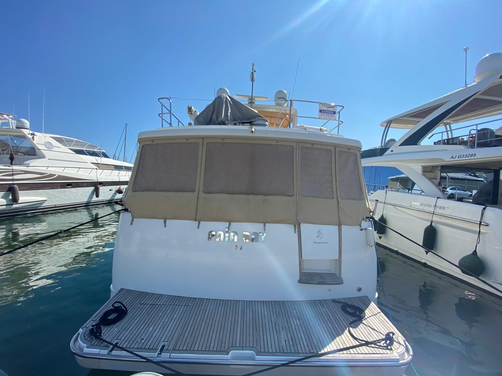 2011 Beneteau Swift Trawler 52 docked at marina under clear blue sky.