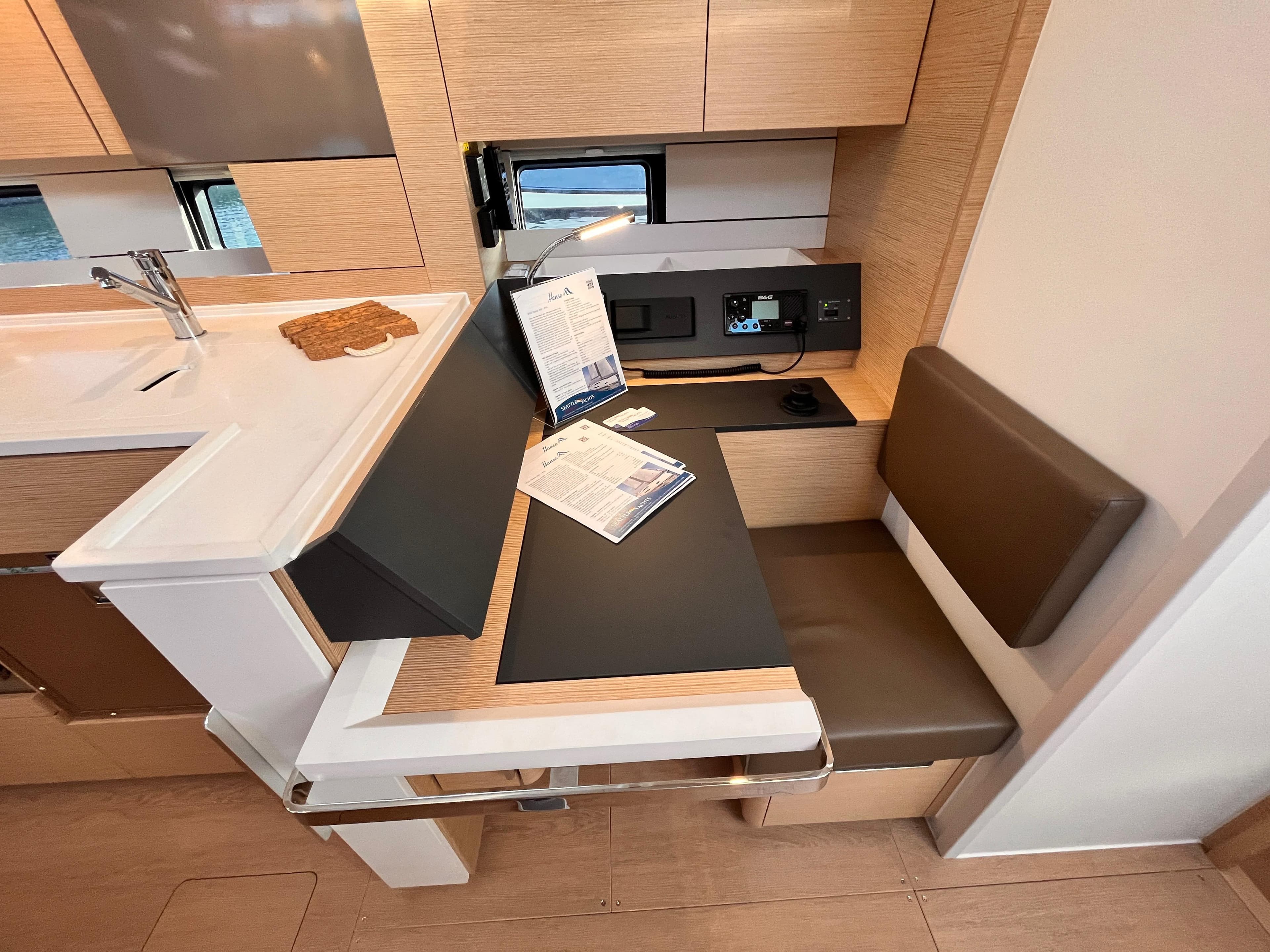 Modern interior of 2023 Hanse 460 yacht with sleek seating and workspace.