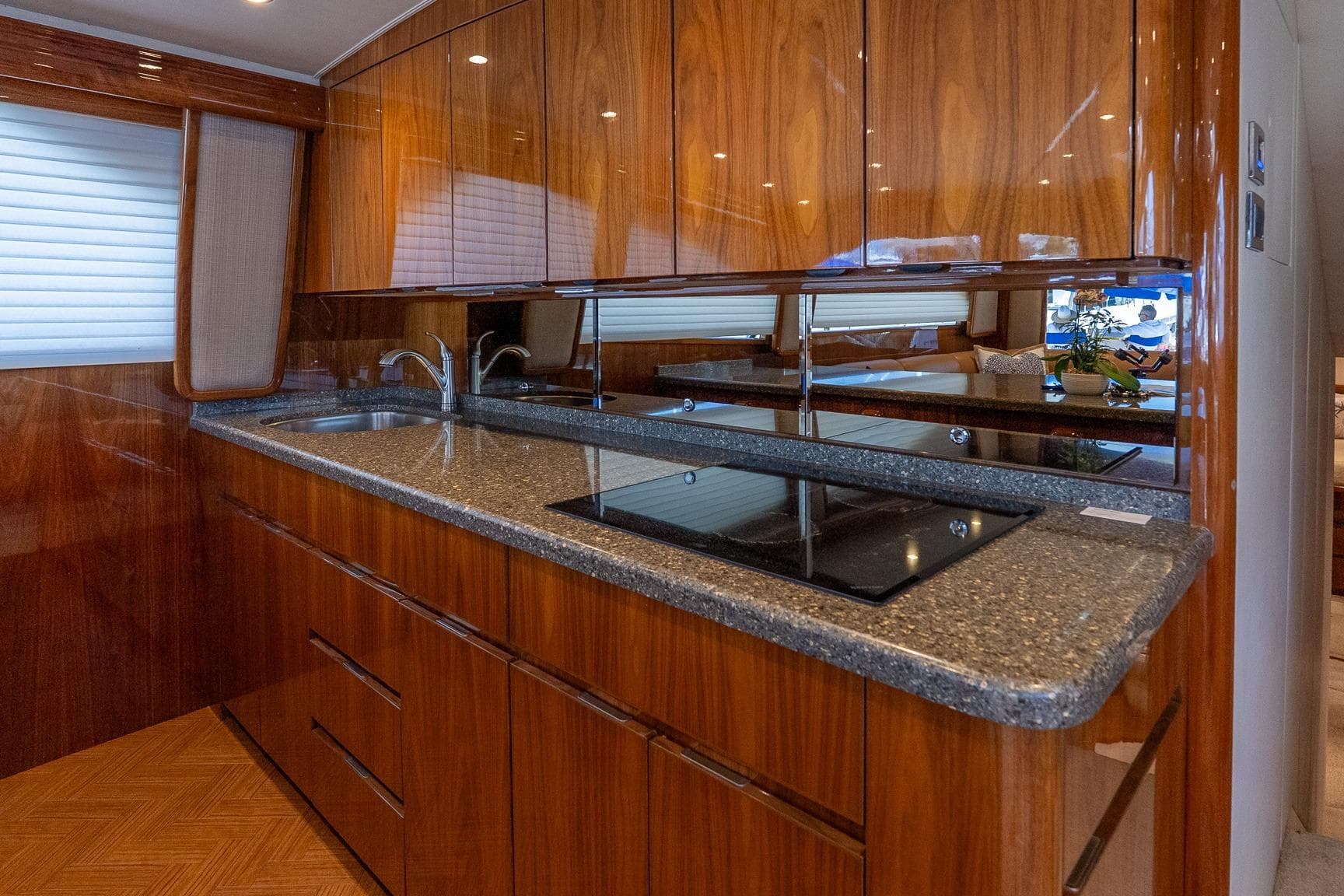 Luxurious kitchen interior of 2017 Viking 62 Enclosed Bridge yacht with wood cabinetry.
