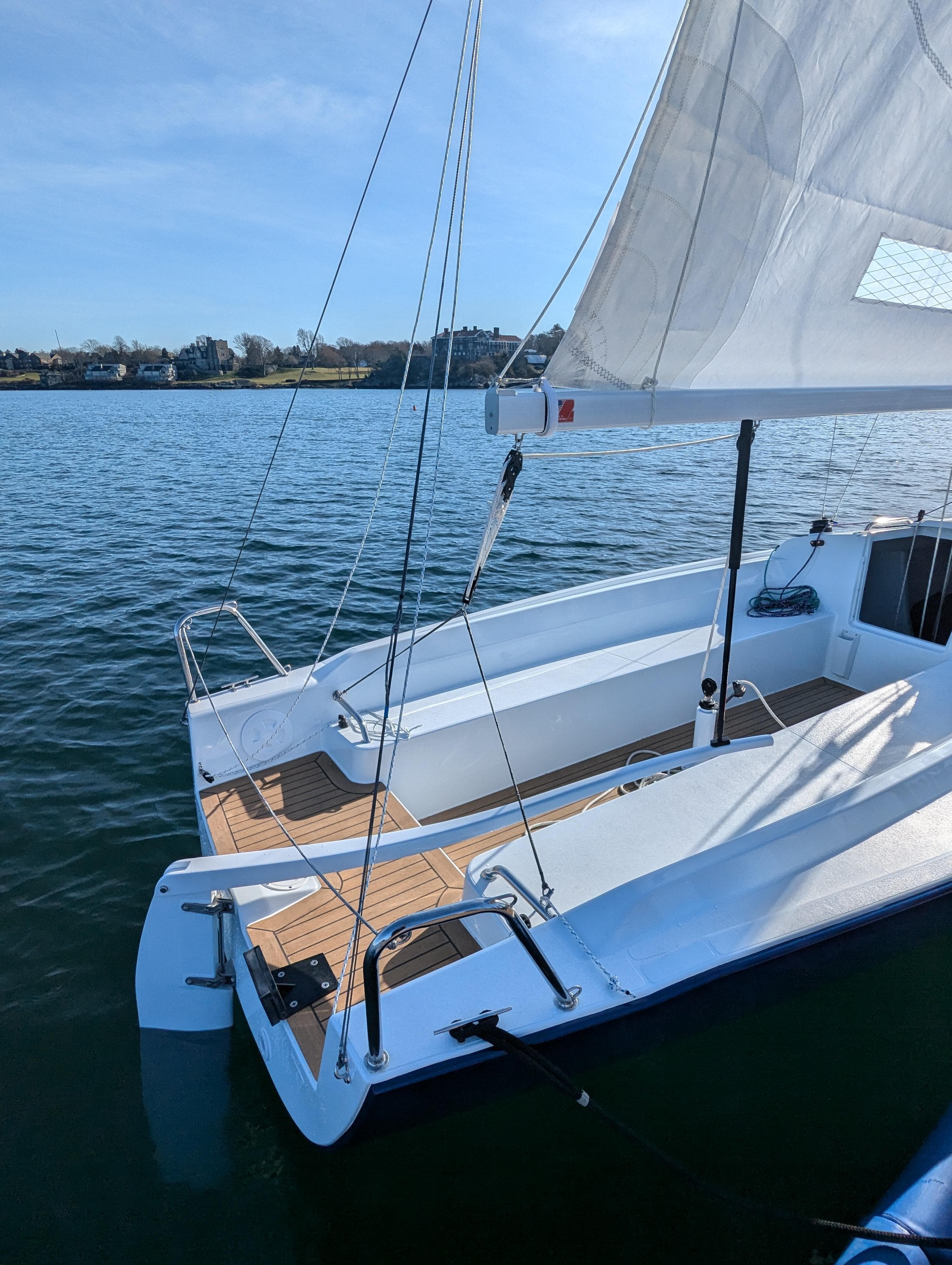 2025 J Boats J 7 sailboat on calm water, showcasing sleek design and open deck.