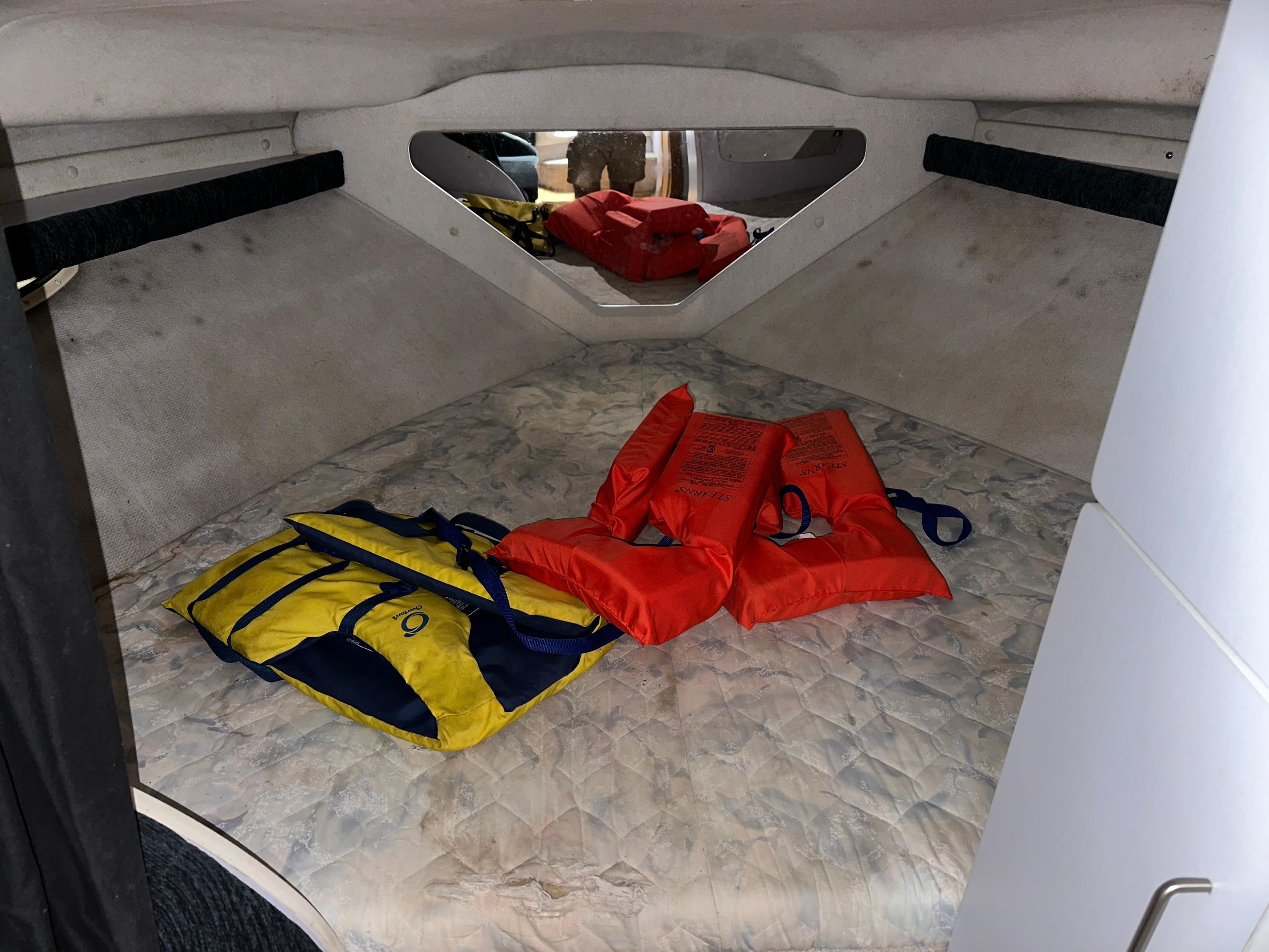 Interior cabin of 1993 Rinker 280 Fiesta Vee with life jackets and storage.