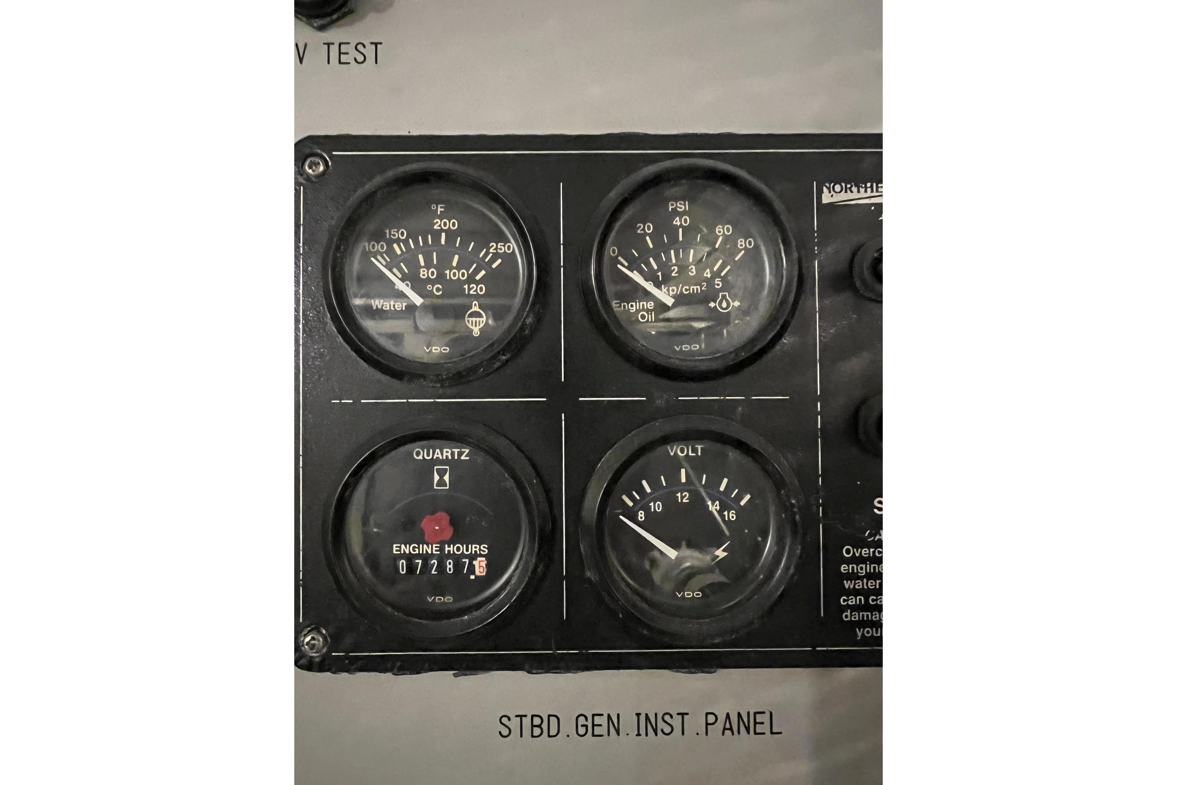 Monte Fino 92 yacht instrument panel with gauges for water temperature, engine oil, hours, and voltage.