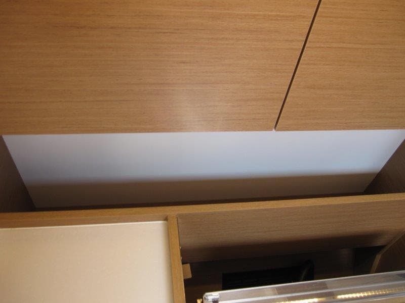 Interior cabinetry of 2025 Jeanneau Sun Odyssey 350 yacht, featuring sleek wooden design.