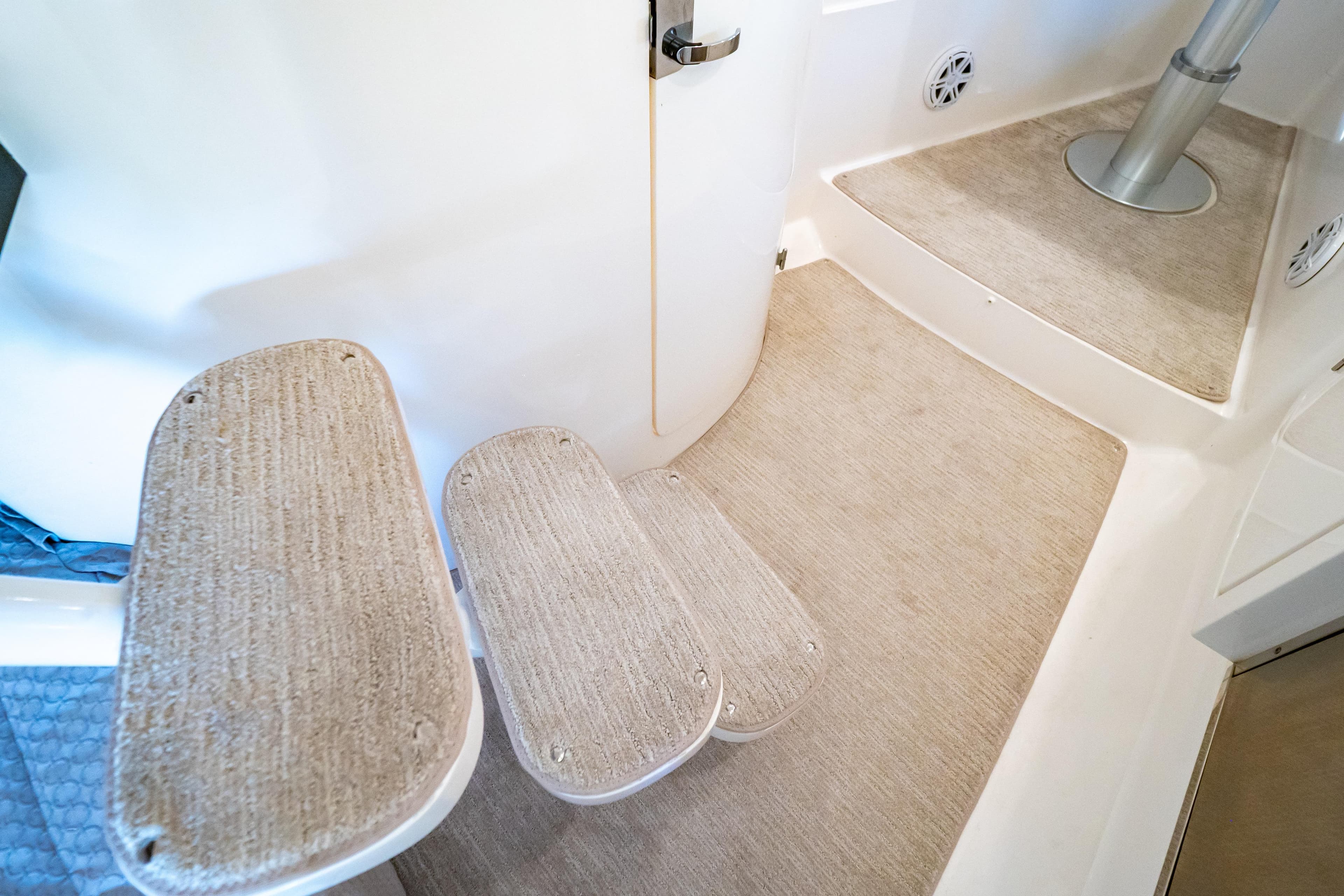 Interior steps of a 2016 Intrepid 400 Cuddy boat, featuring carpeted surfaces.
