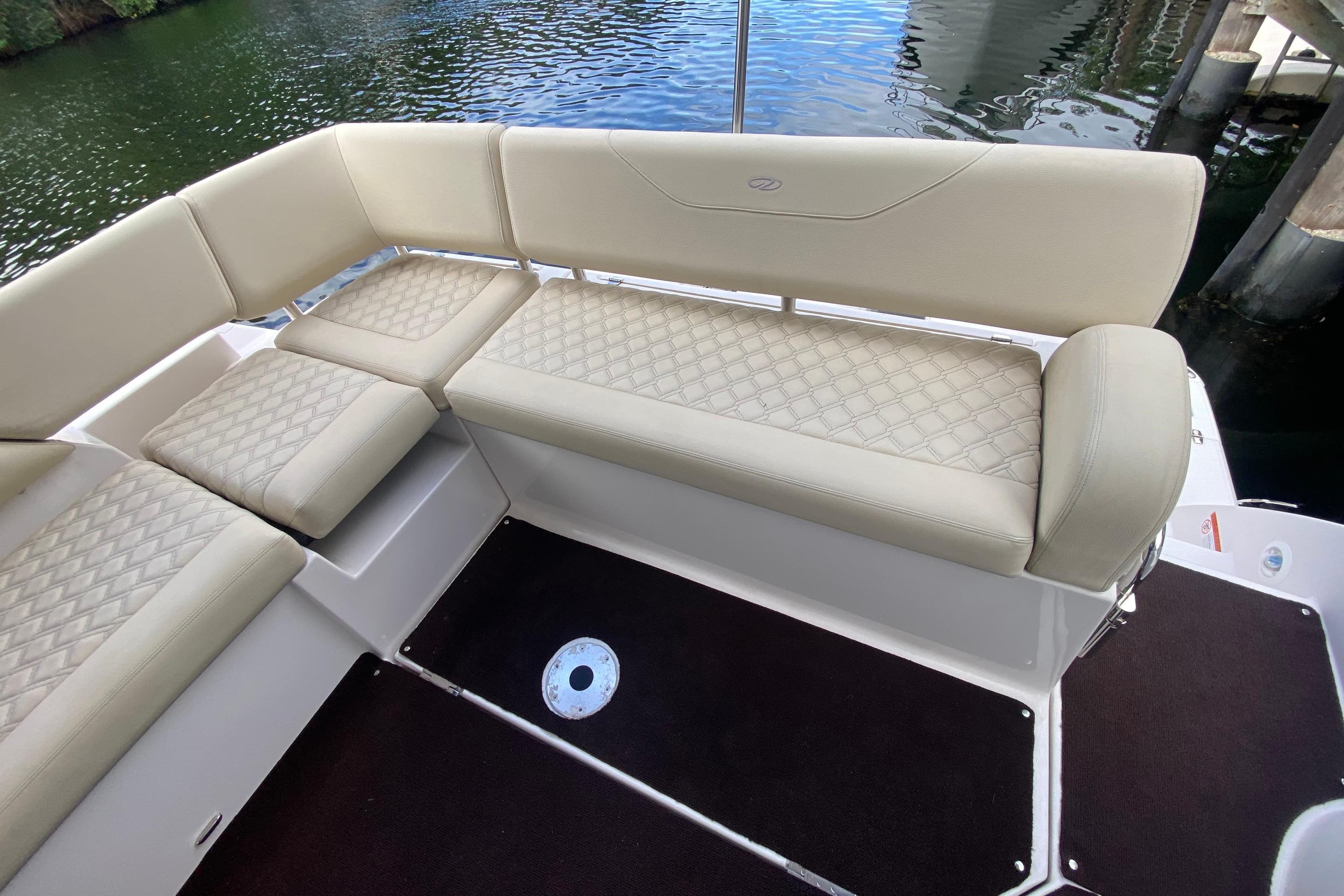 Luxurious seating on 2021 Regal 38 XO boat, featuring elegant diamond-pattern upholstery.