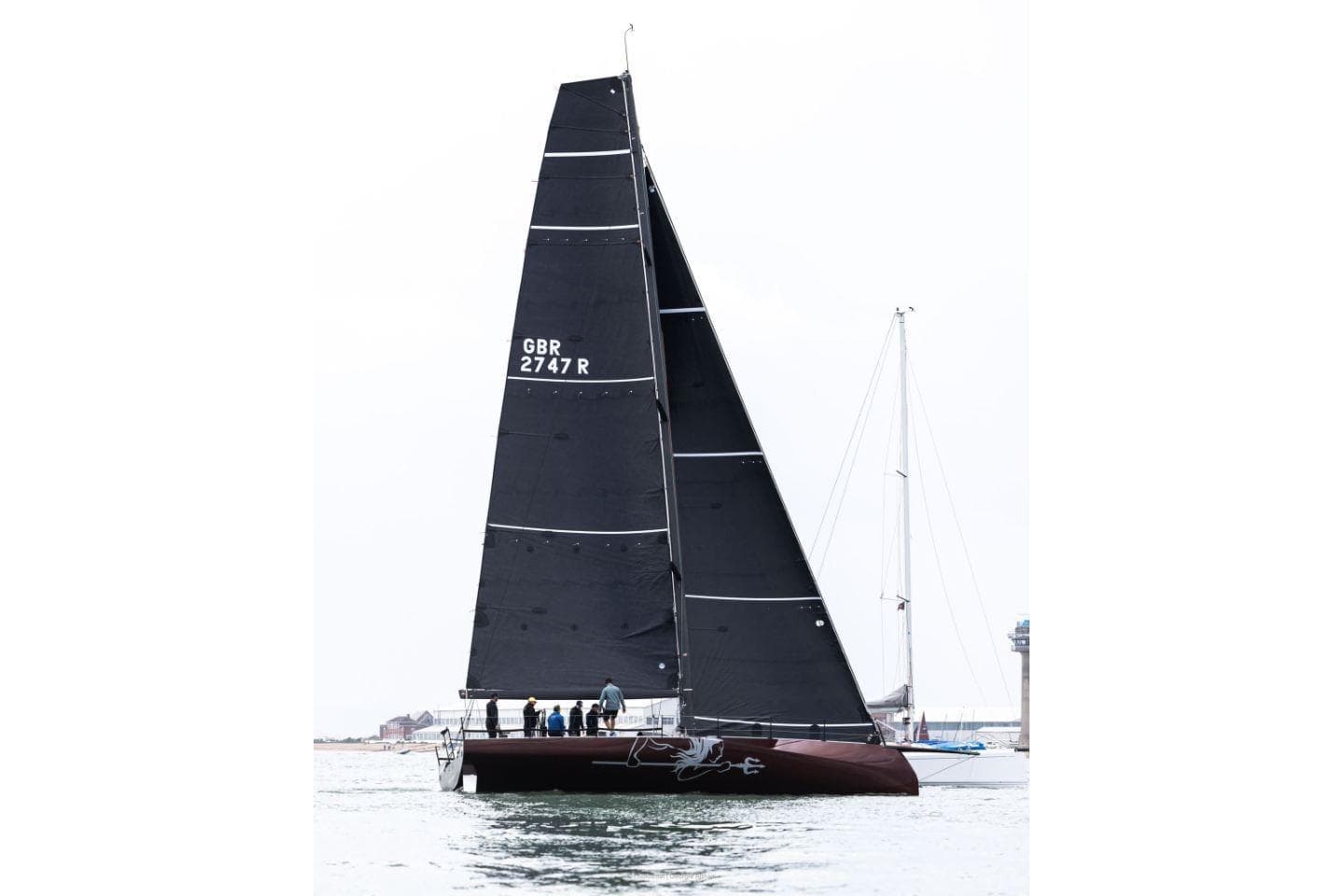 2023 Carkeek 45 sailboat with black sails on open water.