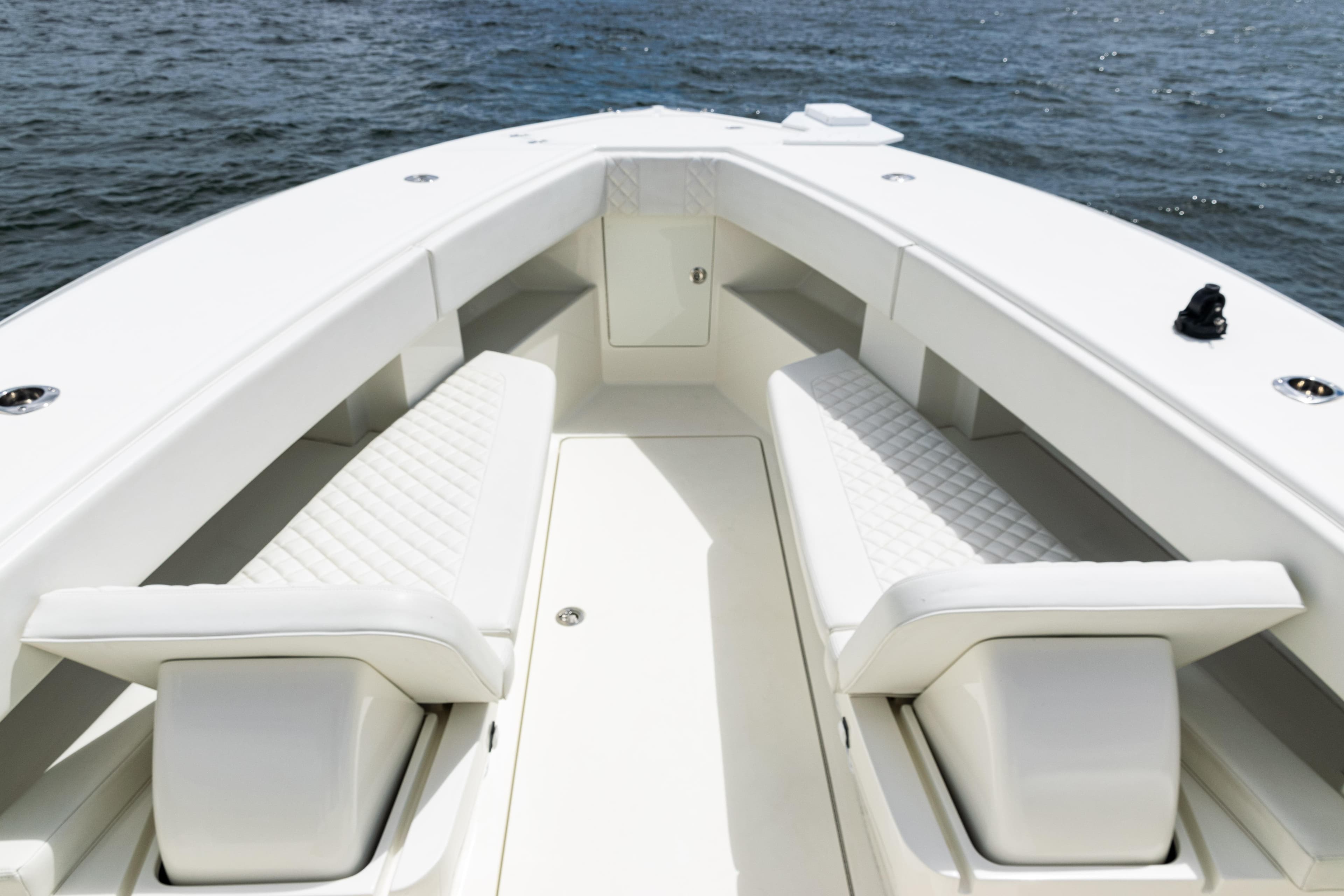 2017 SeaVee 370z boat interior with white seating and ocean backdrop.