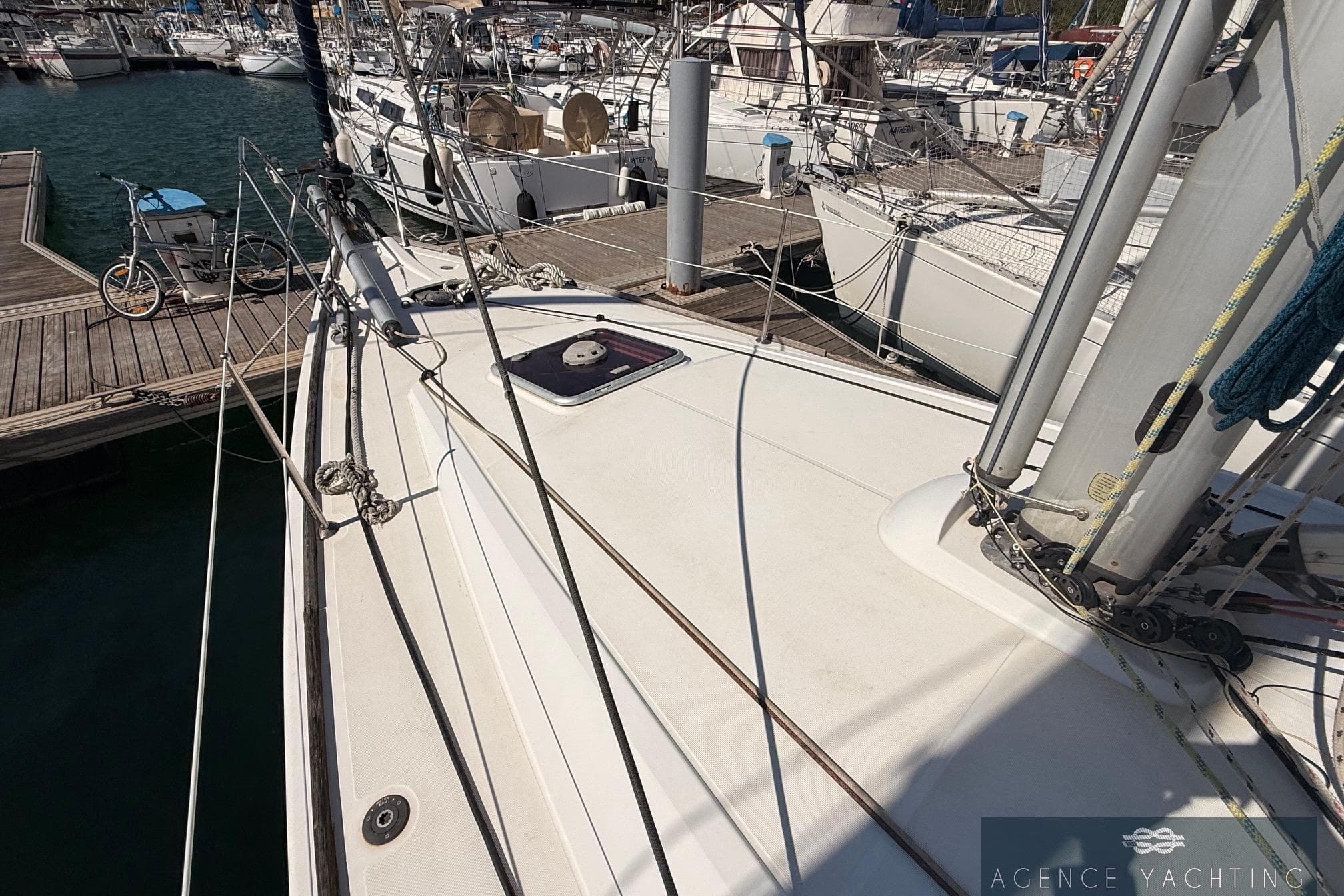 2009 Jeanneau Sun Odyssey 39i Performance sailboat docked at marina, showcasing deck and rigging.