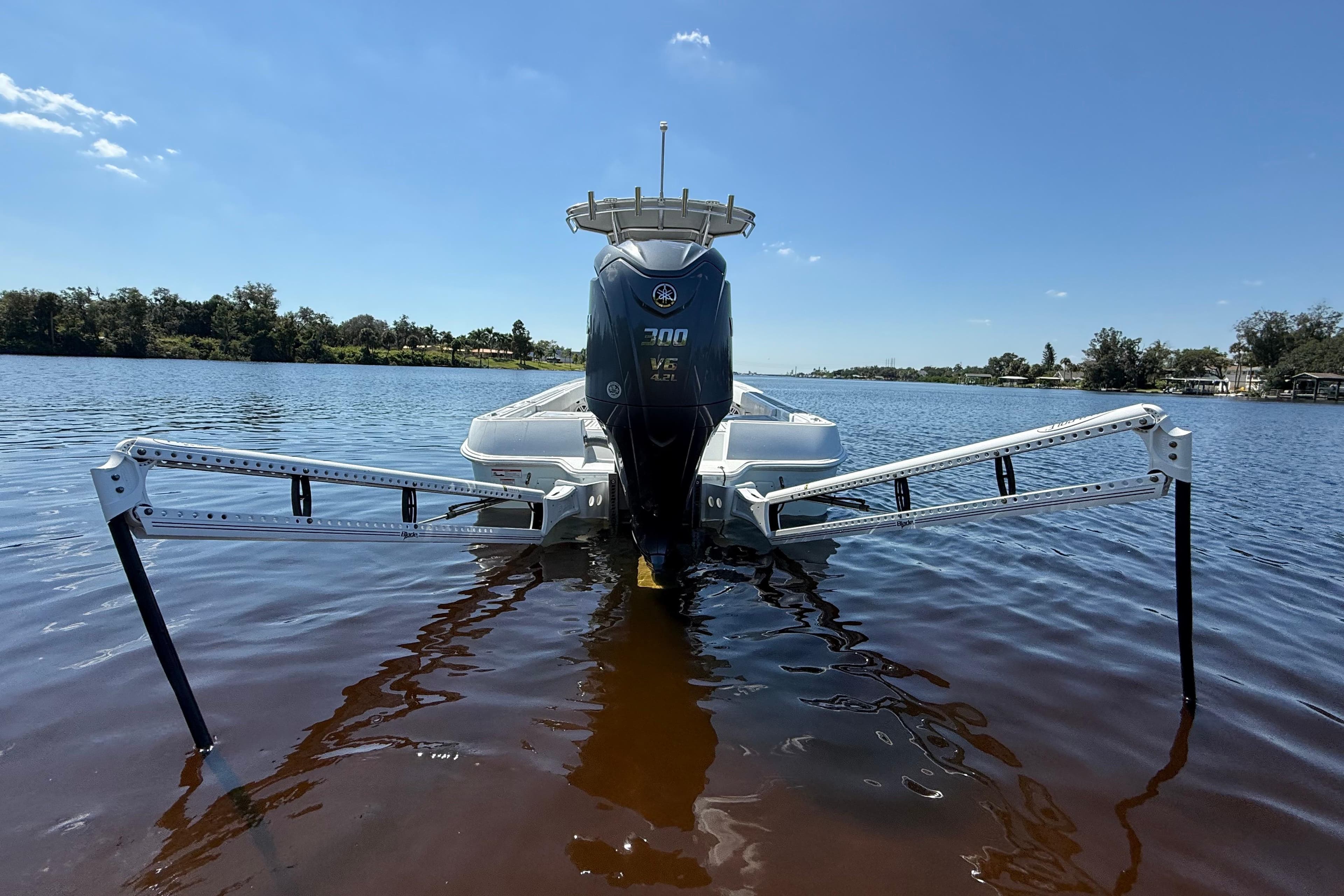 2024 Contender 26 Bay boat with Yamaha 300 V6 engine on calm water.