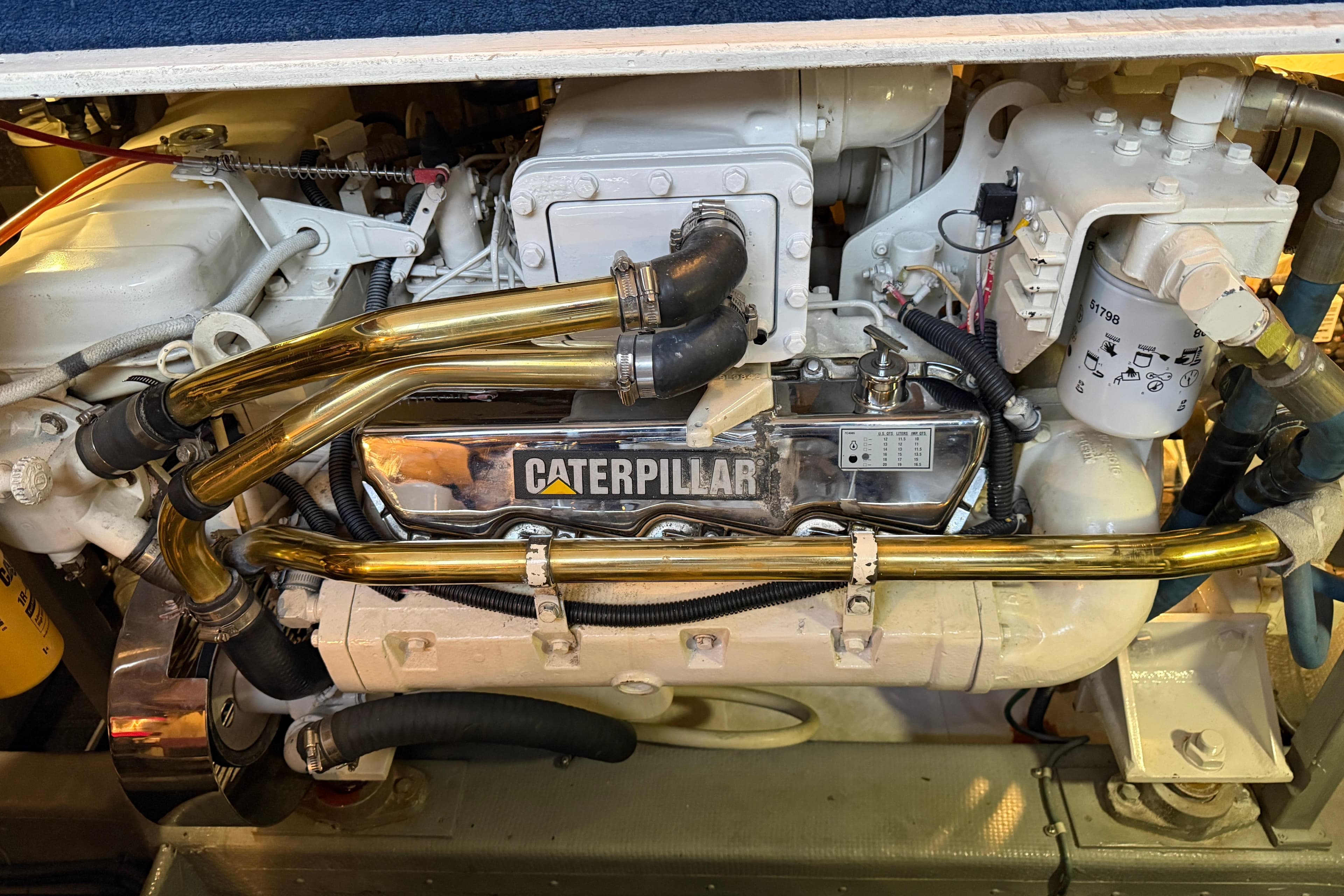 Engine compartment of a 1994 Tollycraft 45 Cockpit Motor Yacht with Caterpillar components.
