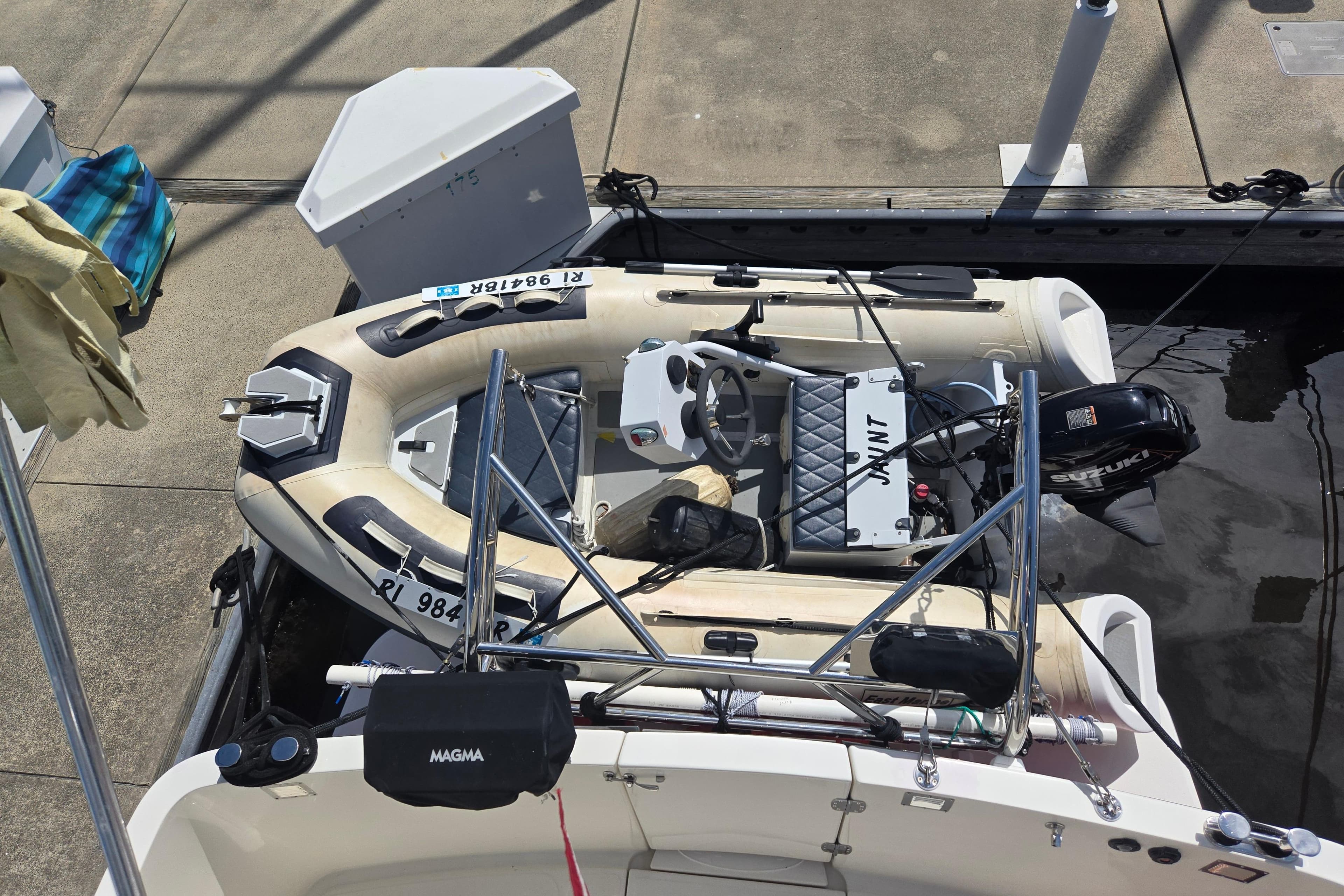 Inflatable boat docked beside a 2012 American Tug 365 Flybridge.