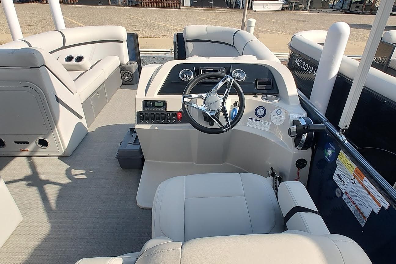 2023 Crest Classic LX 220 boat interior with steering wheel and seating.