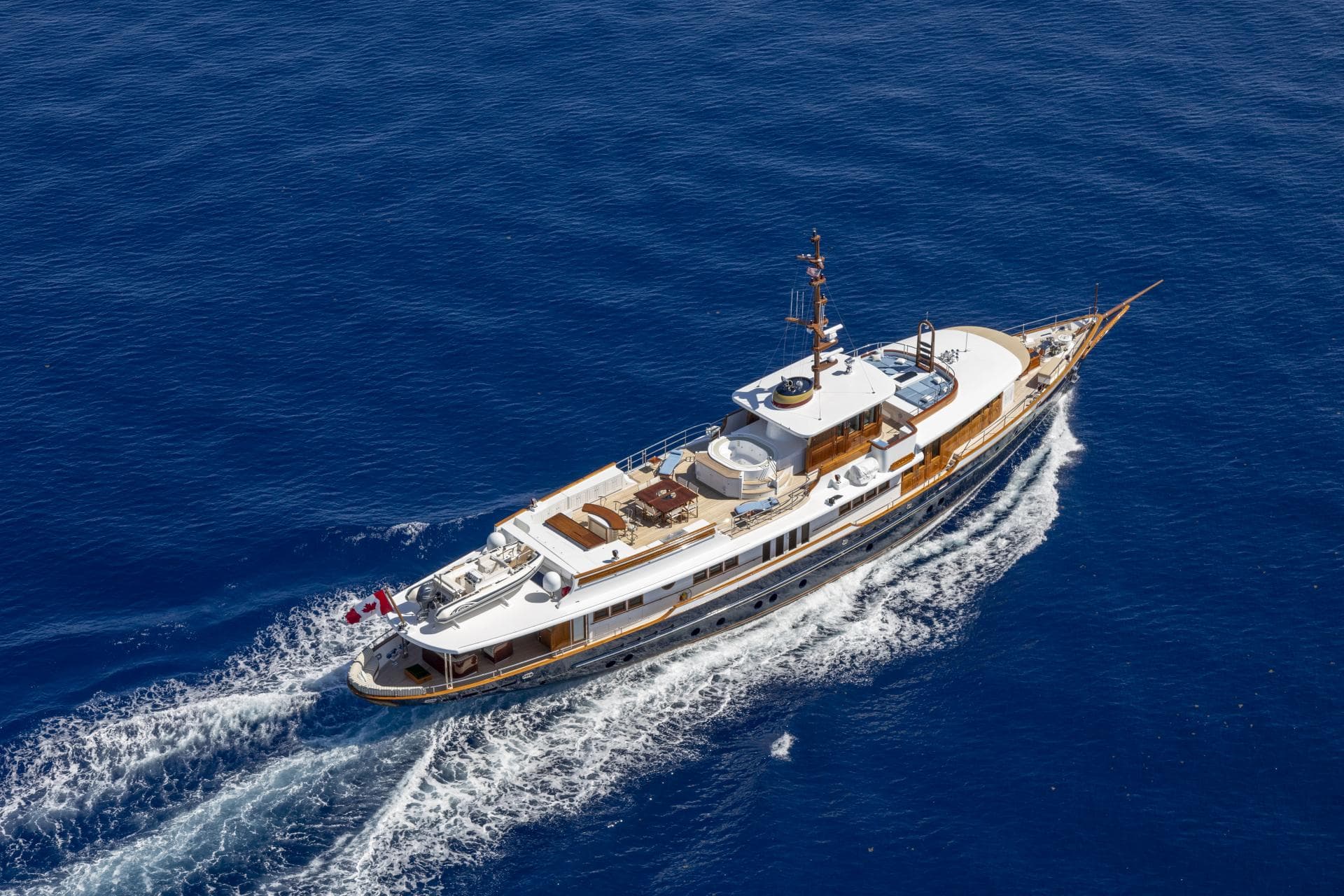 Luxury yacht "NADAN" cruising on open sea, aerial view, 2009 Burger model.