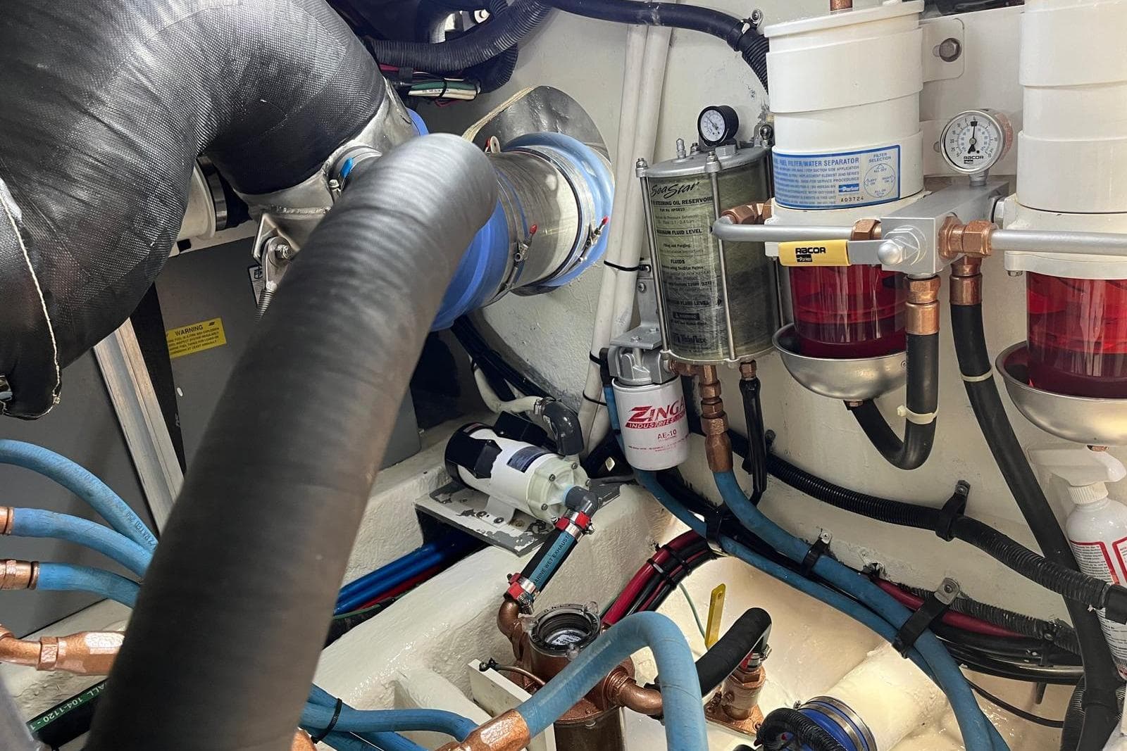 Engine room of 2006 Sea Ray 52 Sedan Bridge with fuel filters and hoses.