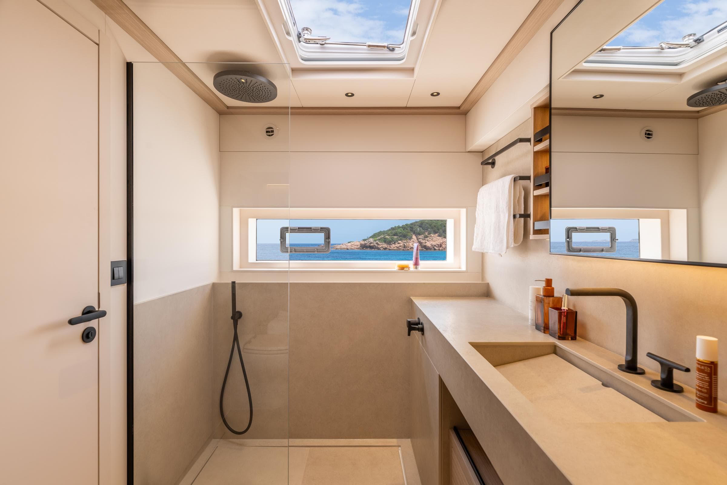 Luxurious bathroom on 2025 Lagoon Eighty 2 yacht with ocean view and modern fixtures.