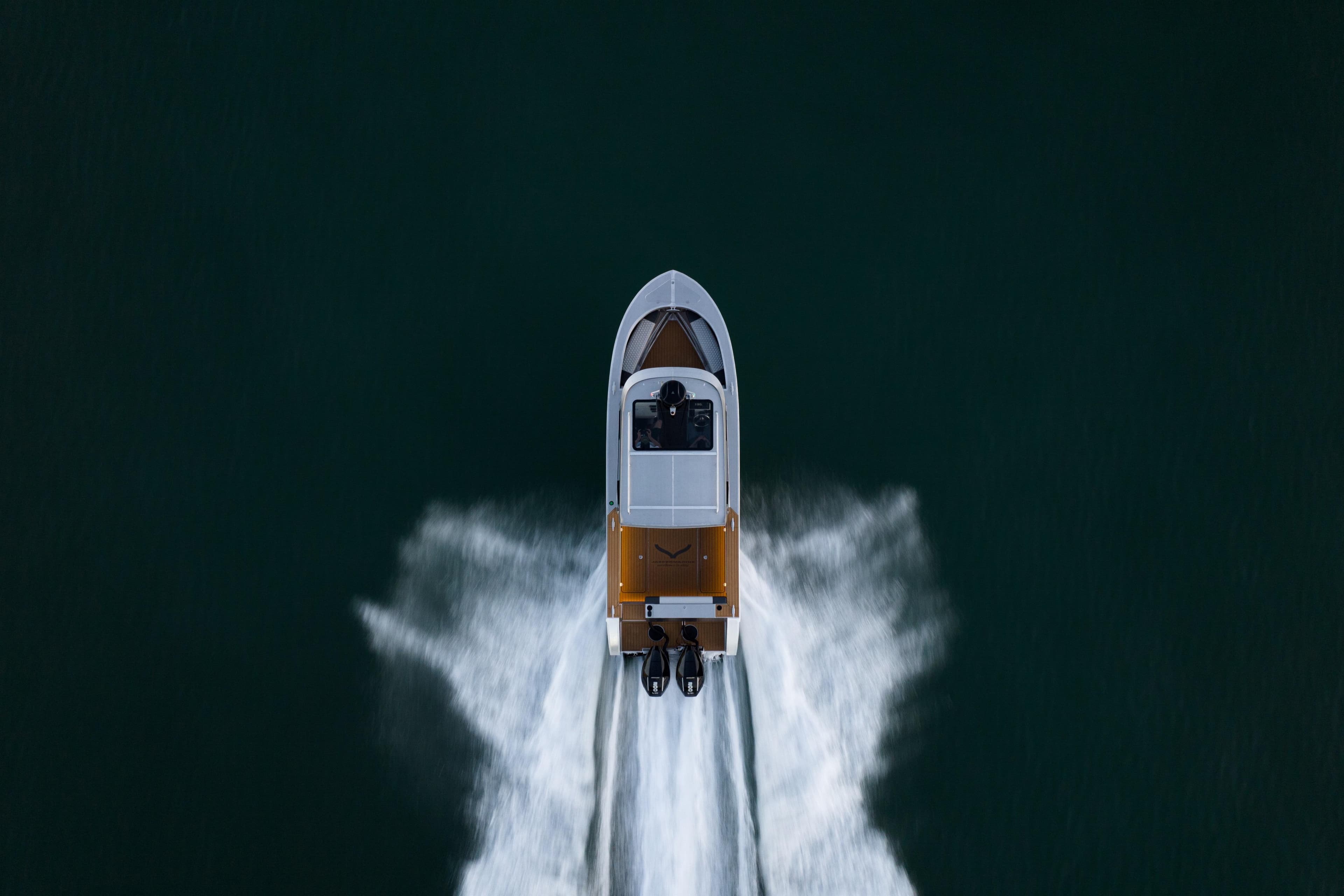 Aerial view of 2026 Jasper Marine Defender 22 boat speeding on water.