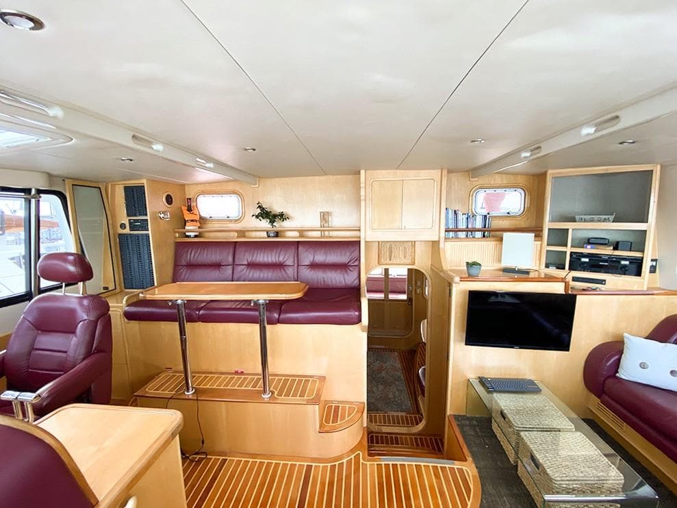 Luxurious interior of 2001 Malcolm Tennant Pachoud Pilothouse Powercat with leather seating and wood finishes.