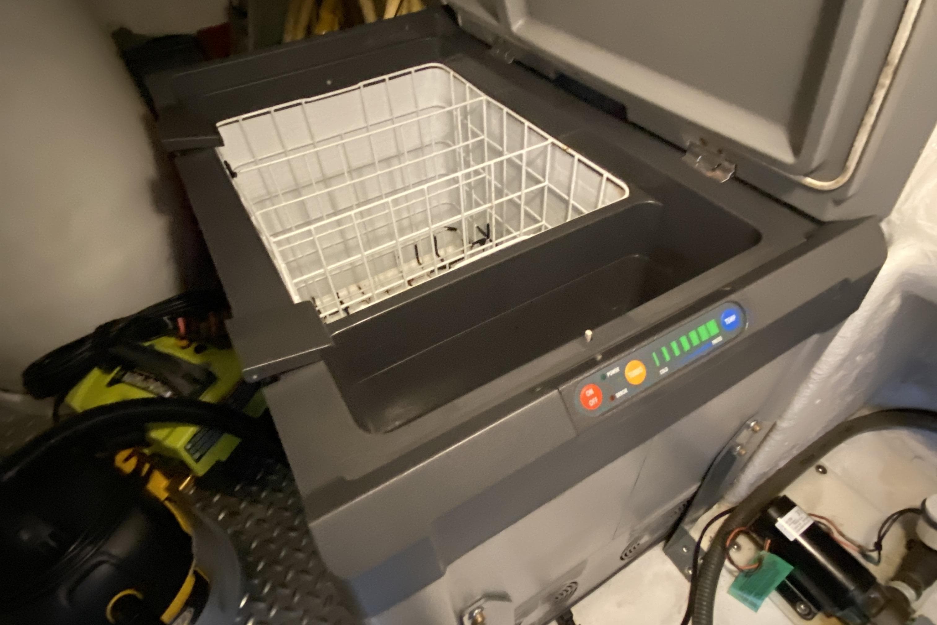 Open Compass 55 cooler with control panel, year 2000 model, in a storage area.