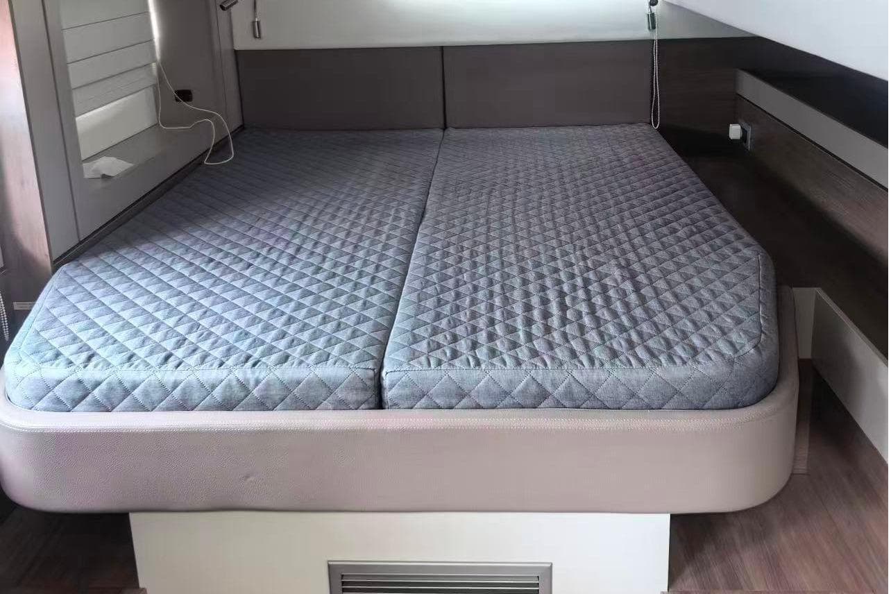 Interior of a 2022 Bali 4.6 with gray mattress.