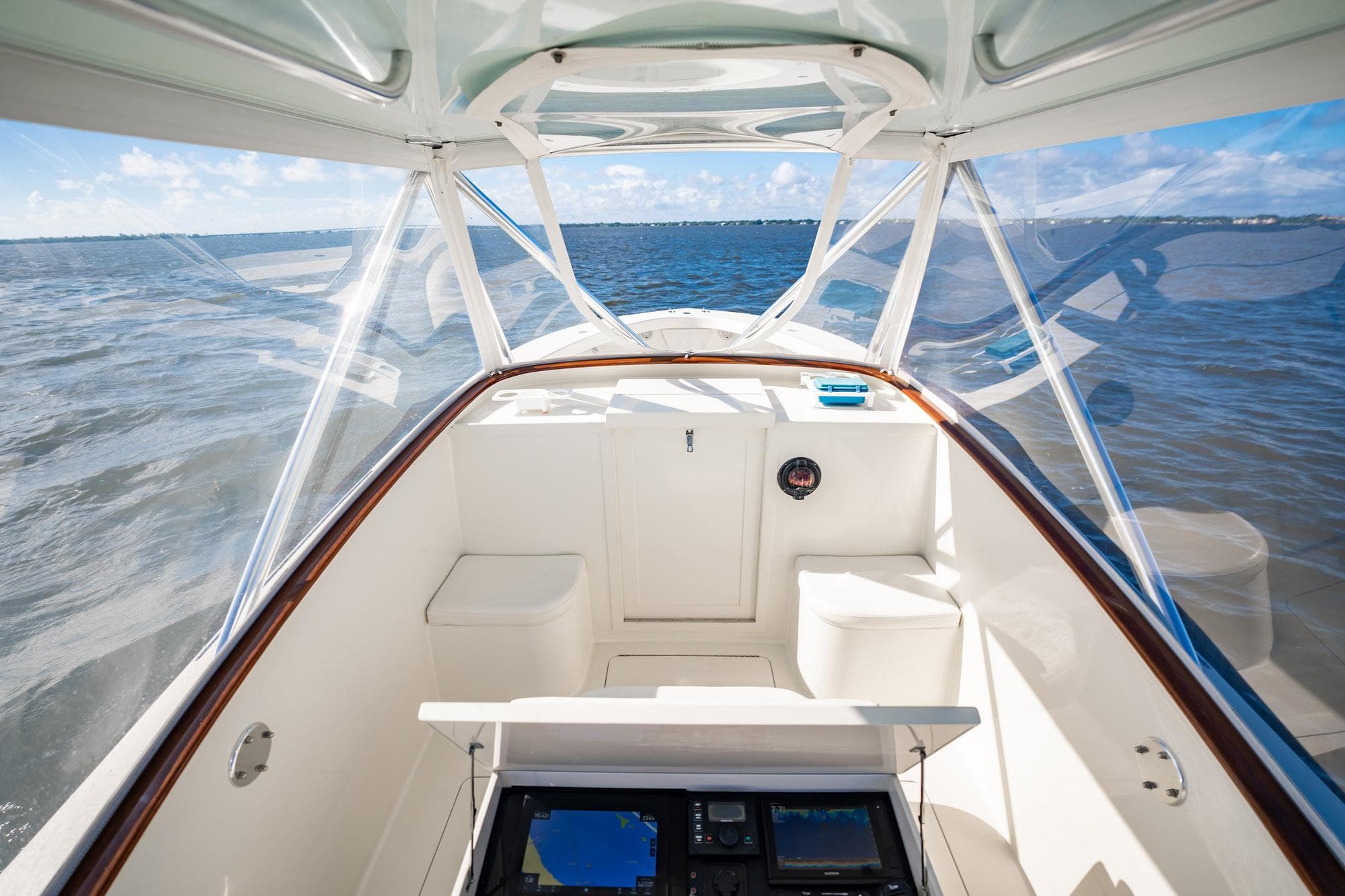 2003 Gamefisherman 34 Express boat interior with ocean view, featuring navigation equipment.