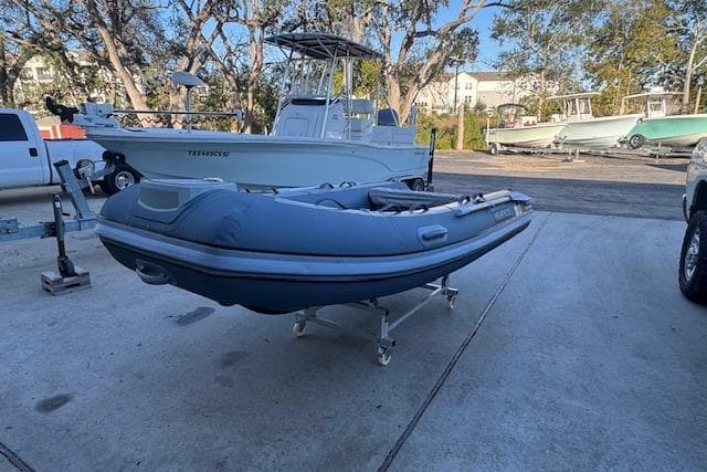 2025 Highfield Classic 340 inflatable boat on a trailer in a marina setting.