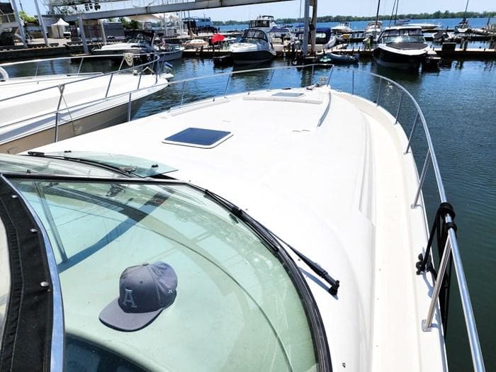 1999 Sea Ray 460 Sundancer yacht docked at marina, sunny day, cap on windshield.