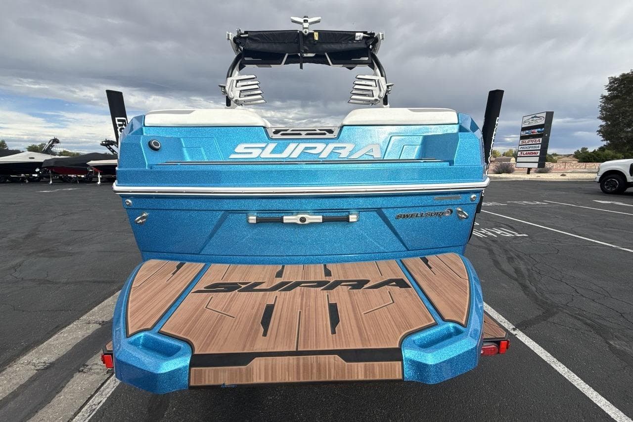 2024 Supra SA 550 boat in vibrant blue, showcasing sleek design and advanced features.
