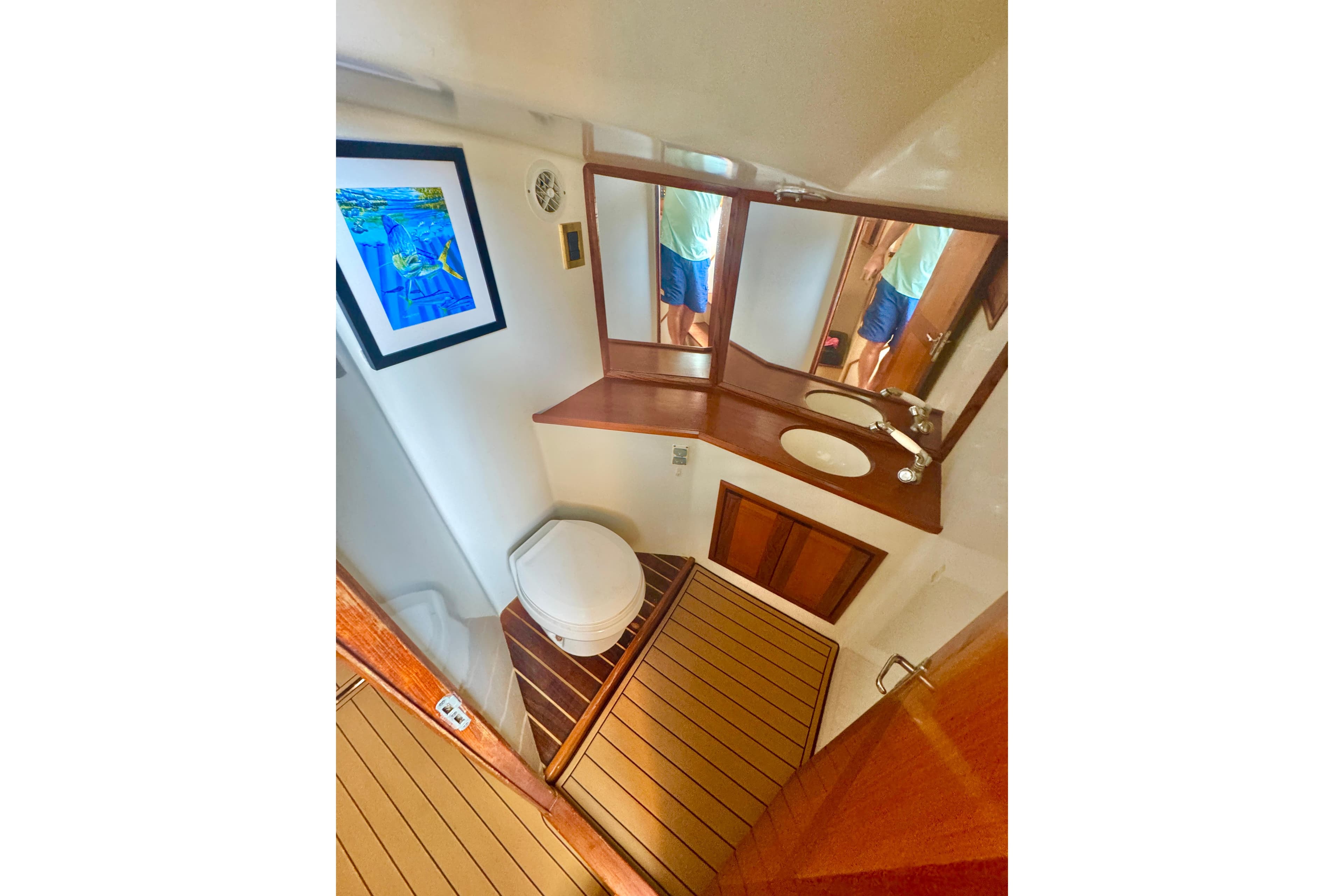 Bathroom interior of 2006 Miller Marine 36 yacht with wooden accents and artwork.
