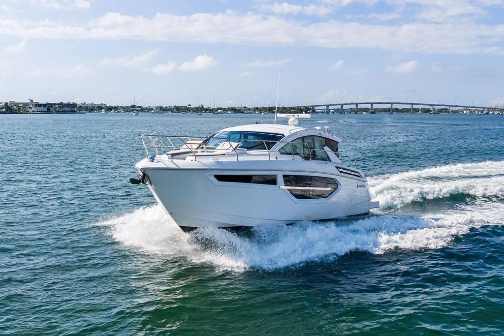 2023 Cruisers 42 Cantius yacht cruising on open water under a clear sky.