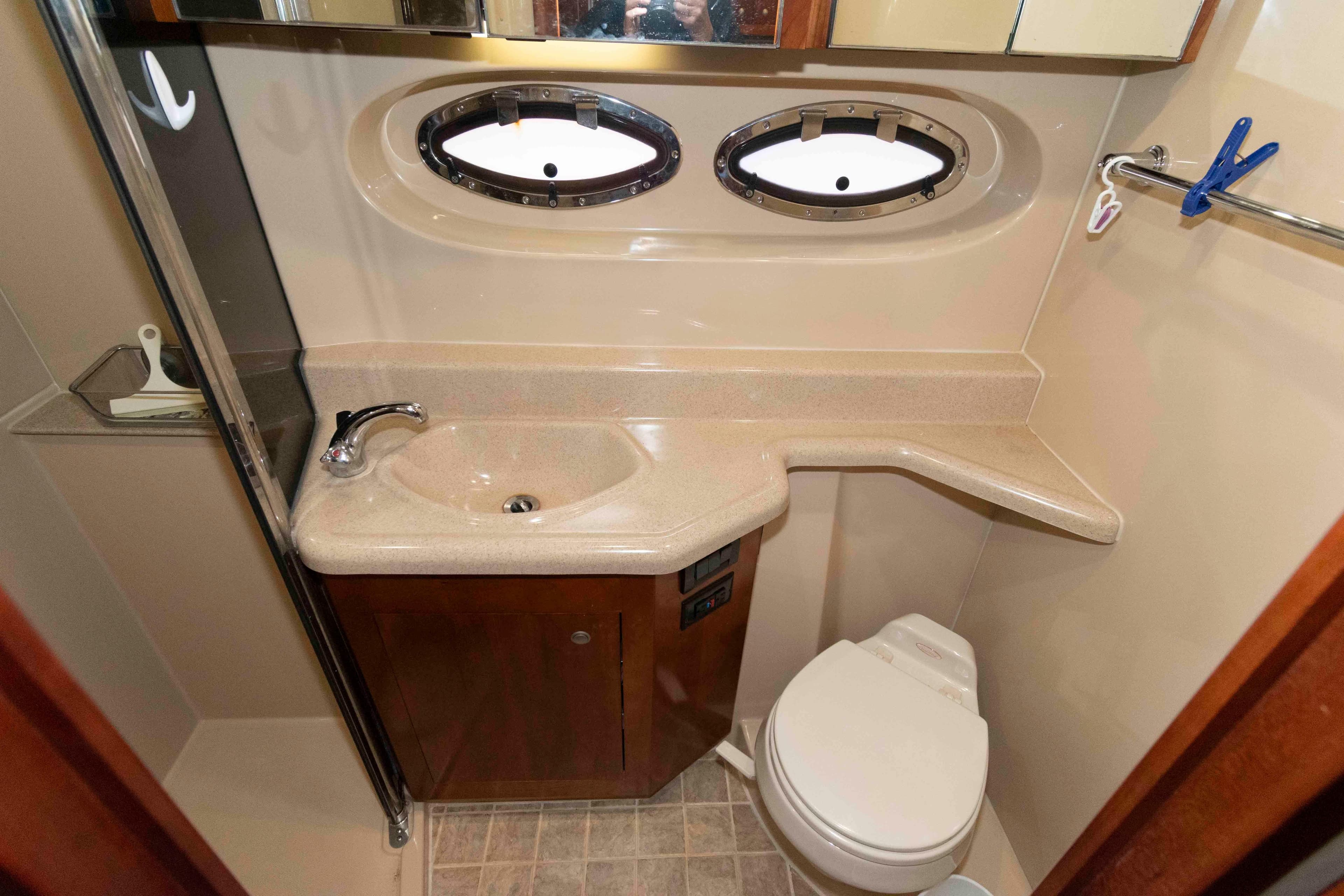 Luxurious bathroom in 2007 Cruisers Yachts 415 Express Motoryacht with sink and toilet.