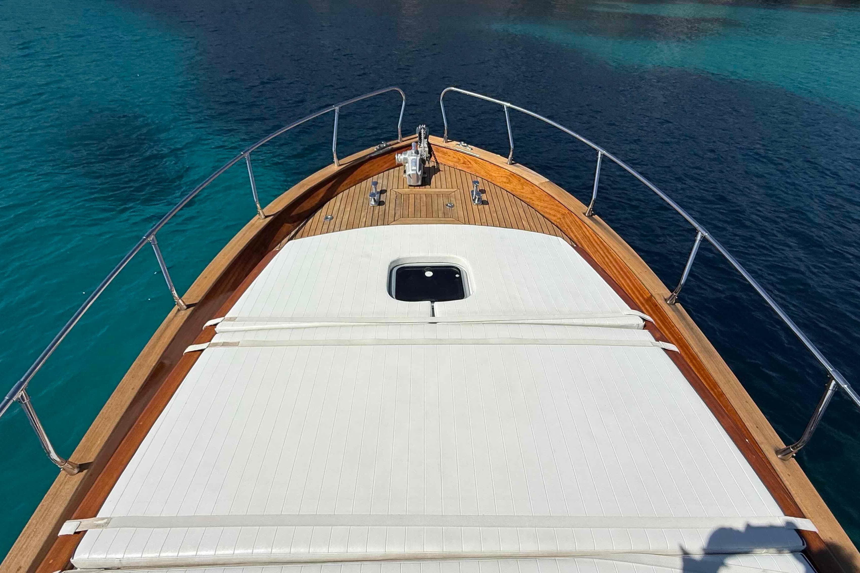 Bow view of 2009 Bani 11,50 Prestige yacht on clear blue water.